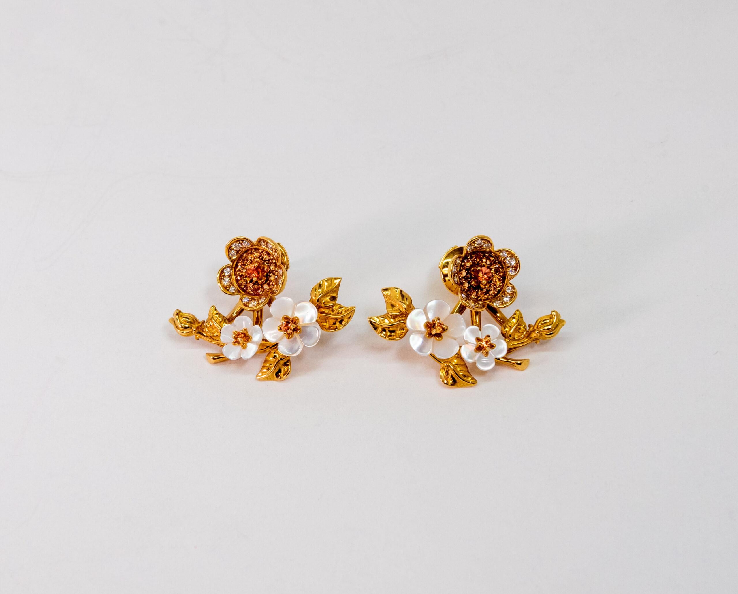 10070436 Carrera y Carrera
This 18K Yellow Gold stud earring is made as spring of flowers. Two Mother of Pearl flowers set with 2 orange diamonds. Third flower figure set with 15 White diamonds and 11 Orange Diamonds. Diamonds are totaling ~0.20ct.