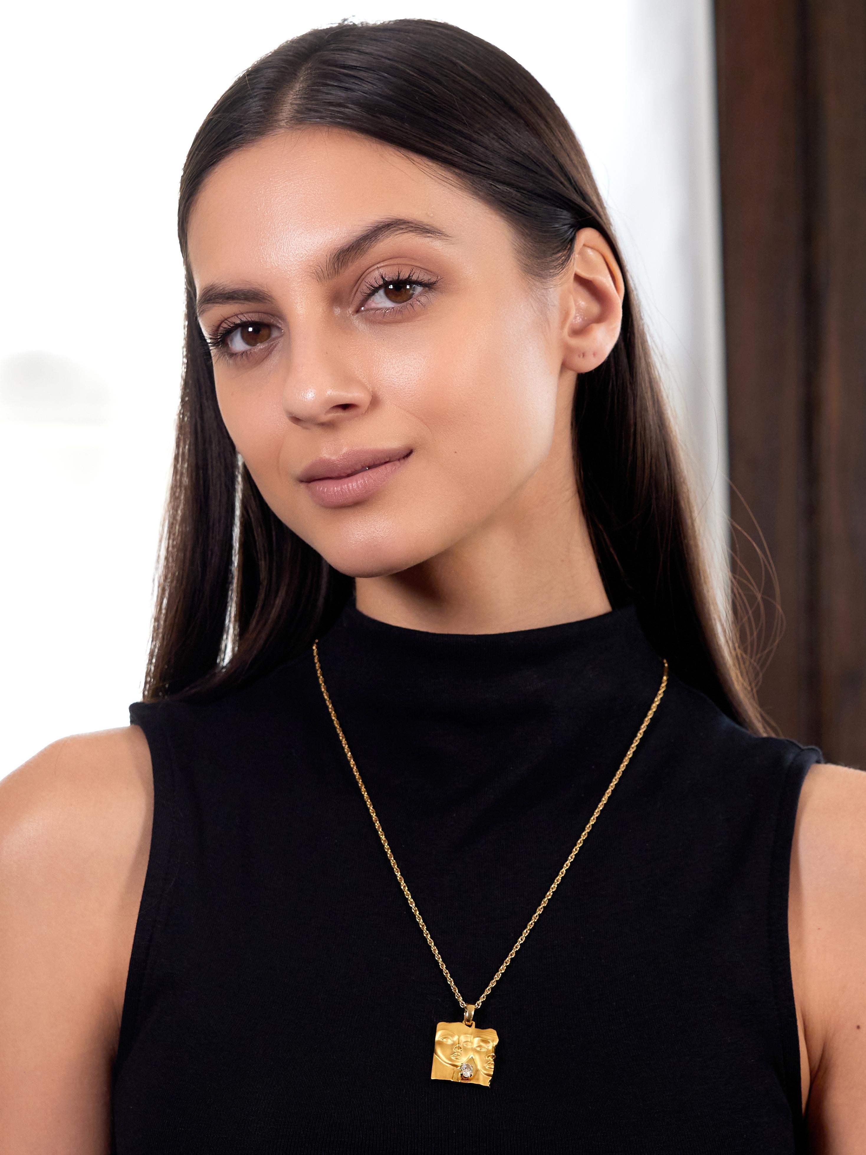 Comprised of a spiga link chain suspending a square form pendant form tapered bale
Carved to depict a portrait of a man and woman intended to be Adam & Eve
Matte gold with high polish organic edges and negative space
Prong set with an oval cut