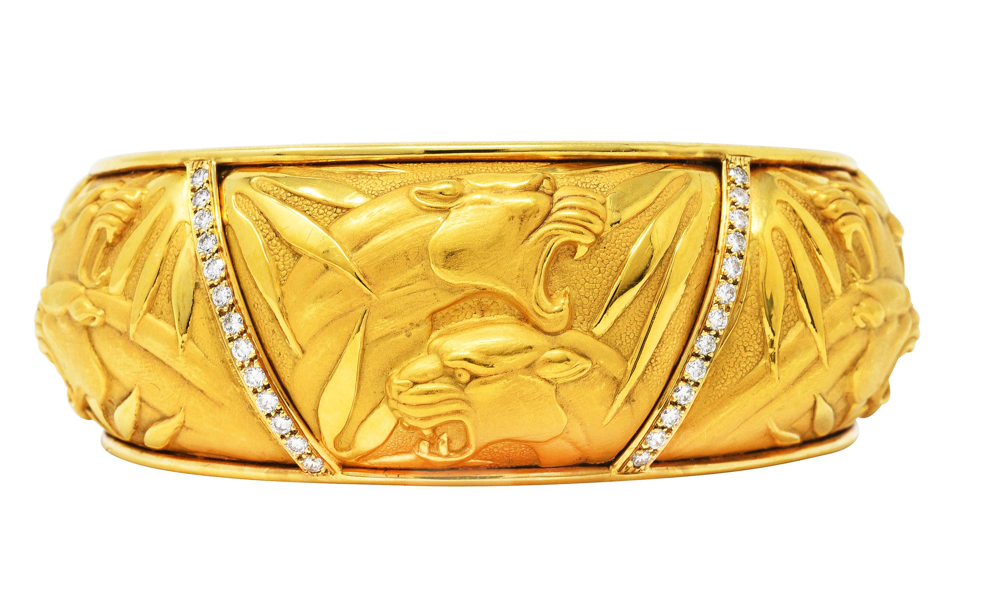 Cuff bracelet featuring five repoussè panels depicting highly rendered matte gold panthers

With high polished frame surround with two rows of pavè round brilliant cut diamonds

Weighing approximately 0.65 carat total - G/H in color with VS