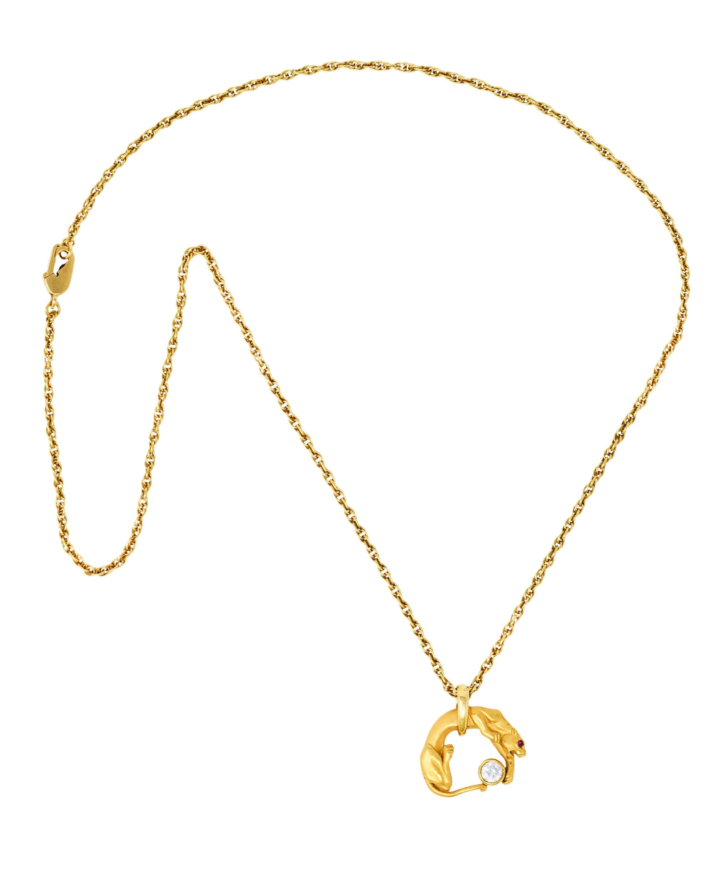 Spiga chain necklace suspends an arched panther pendant with a matte gold finish

Panther is accented with a ruby eye while pawing a bezel set round brilliant cut diamond

Weighing approximately 0.25 carat with G color and VS1 clarity

Completed by