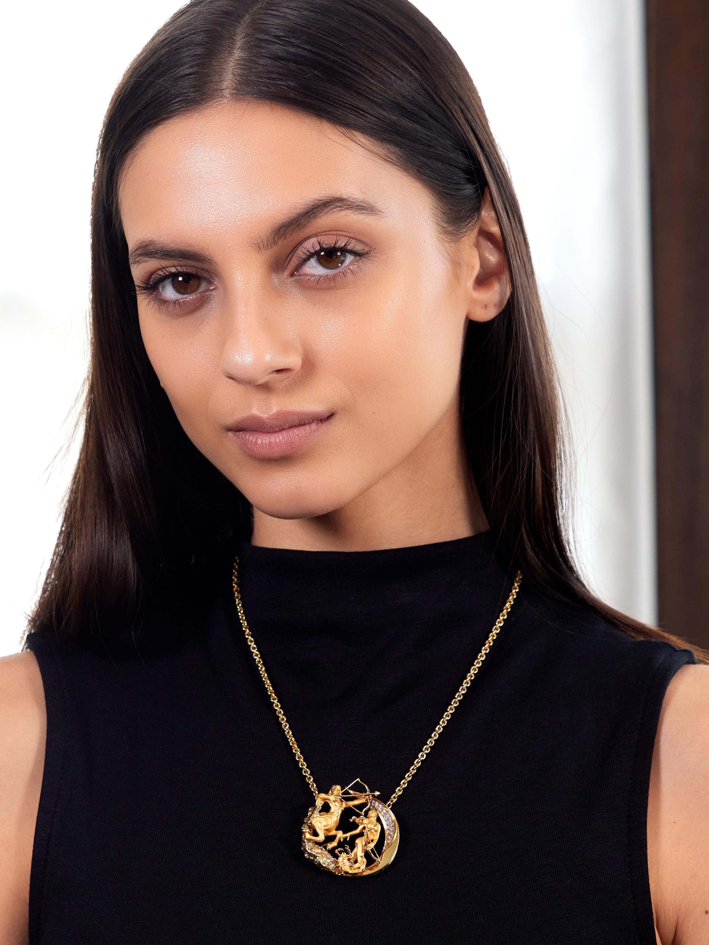 Comprised of a cable link chain centering a round disk station with highly rendered figures
Designed as a mythological scene associated with the astrological sign Sagittarius
Depicting the centaur Chiron, the goddess Artemis, and a scorpion
With