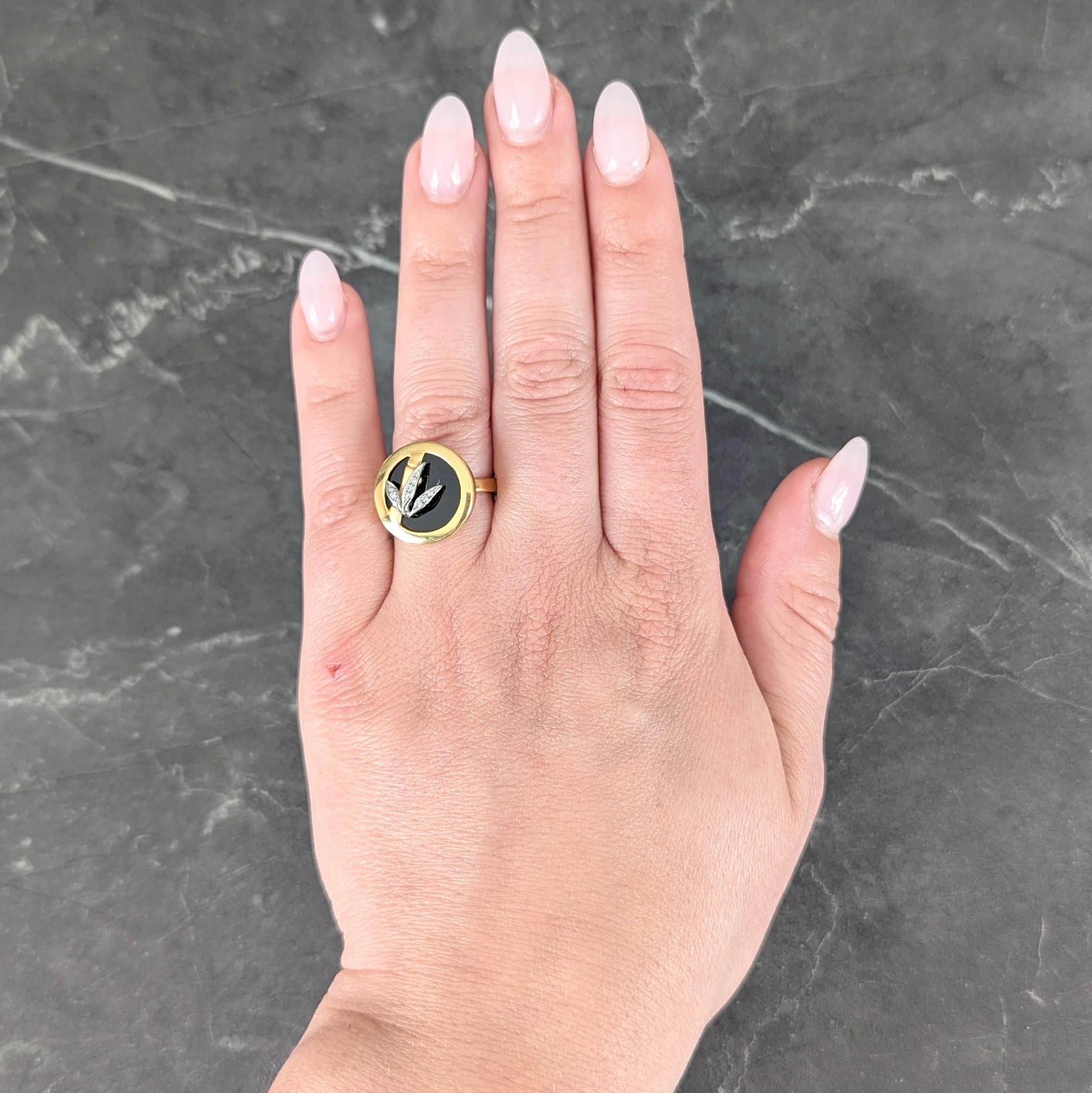 Designed as a round shaped face featuring a matte gold bamboo branch
With white gold foliate appliqué bead set with round brilliant cut diamonds
Weighing approximately 0.05 carat total - eye clean and bright
Overlayed atop an inlaid onyx table