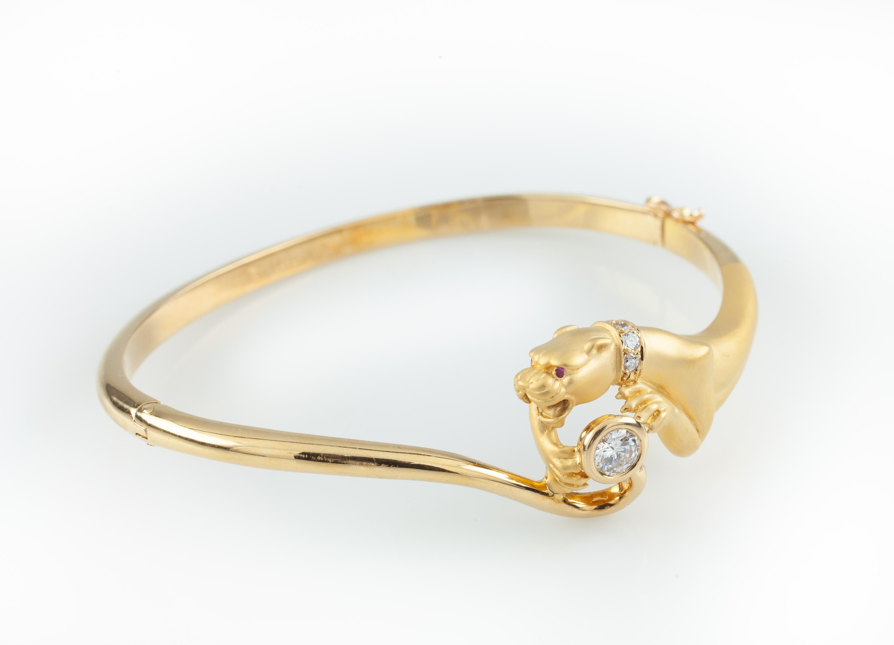 Gorgeous 18k Yellow Gold Bracelet by Carrera y Carrera
Features Matte-Finish Panther w/ Diamond Collar and Pink Sapphire Eyes Holding Diamond Sapphire
Width of Panther Element = 16 mm
Inner Circumference (Wrist Fit) = 6.25