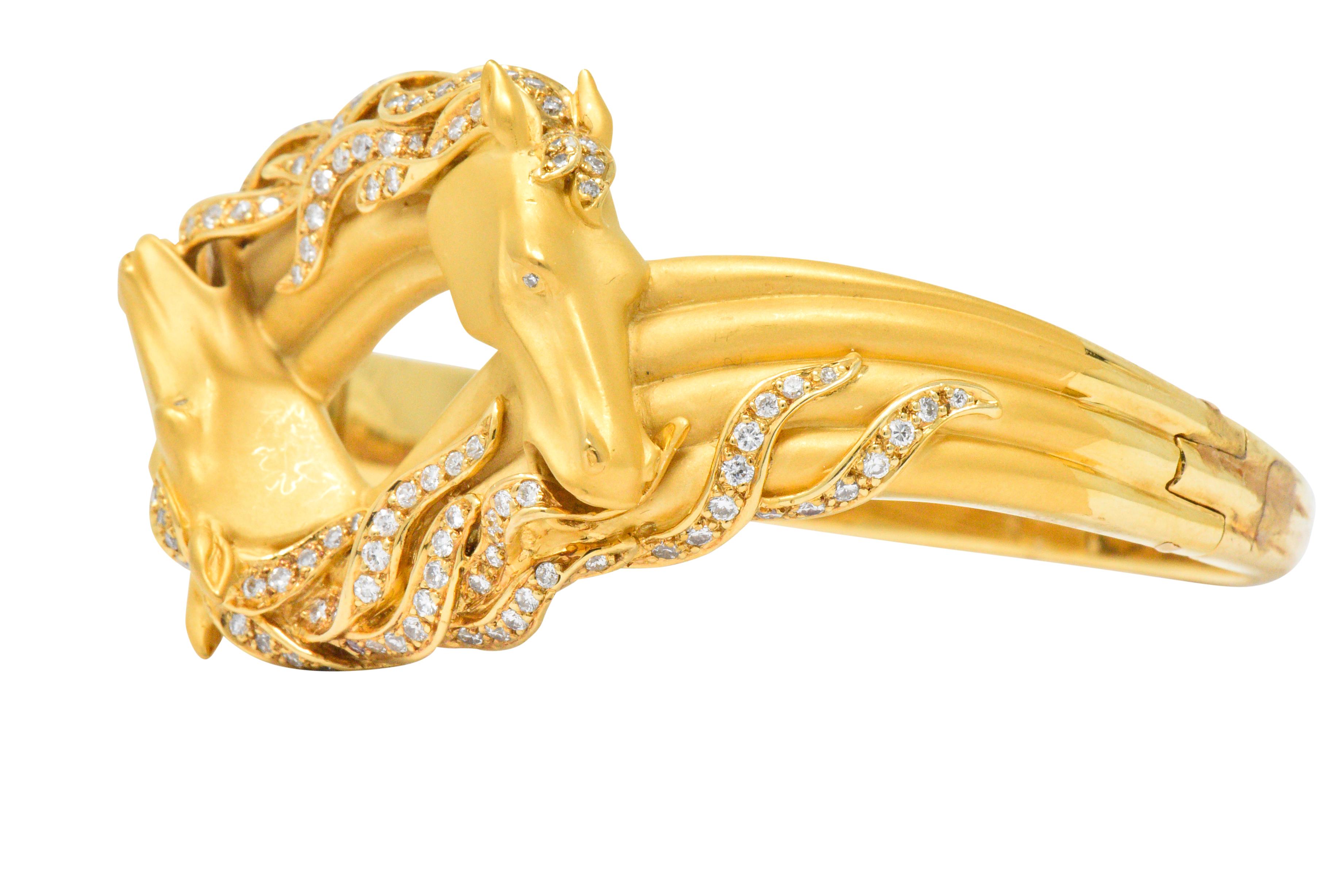 Featuring matte gold horse heads with diamond set eyes in a by-pass look presentation

Flowing manes set with round brilliant cut diamonds weighing approximately 1.45 carats total, G/H color and VS clarity 

Part of the Ecuestre collection

Hinged
