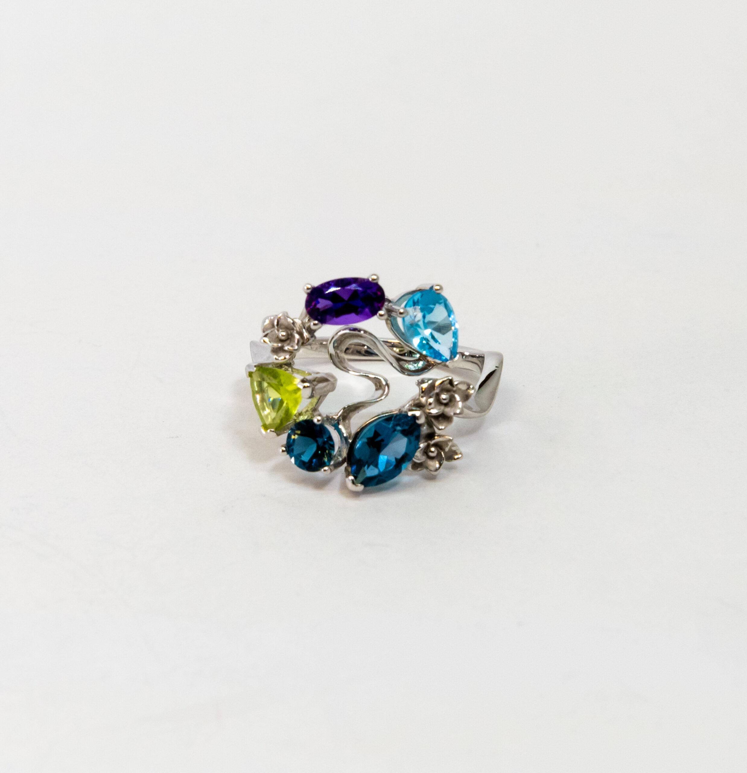 This ring is made of 18K White Gold. The ring set with light blue, purple, and light green sapphires totaling ~2.18ct.

Size – 53.5 (6.5 US)