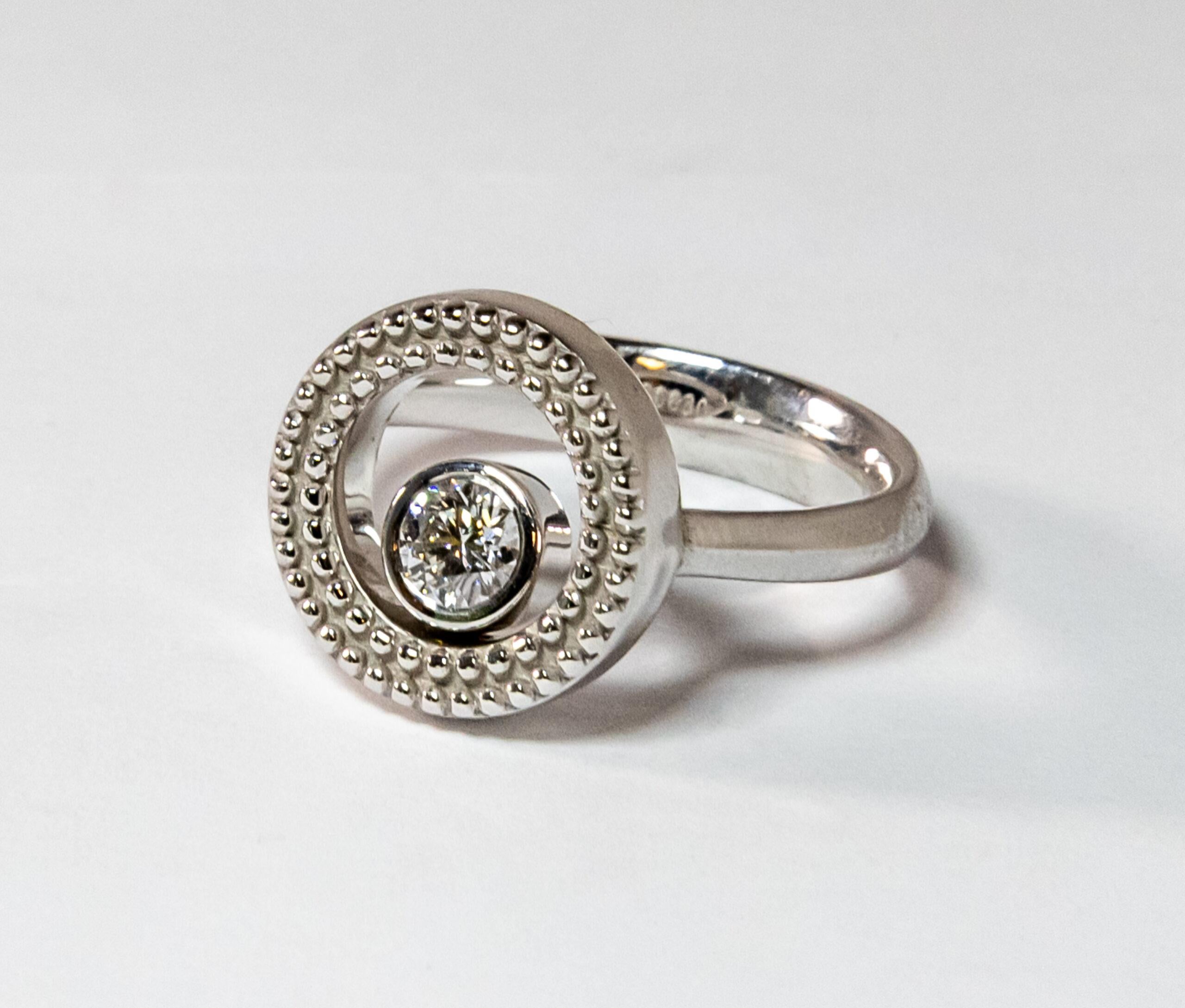 This ring is made of 18K White Gold. It is decorated with floating round-cut diamond (~0.25ct).

Size – 54 (7 US / 14 mm)