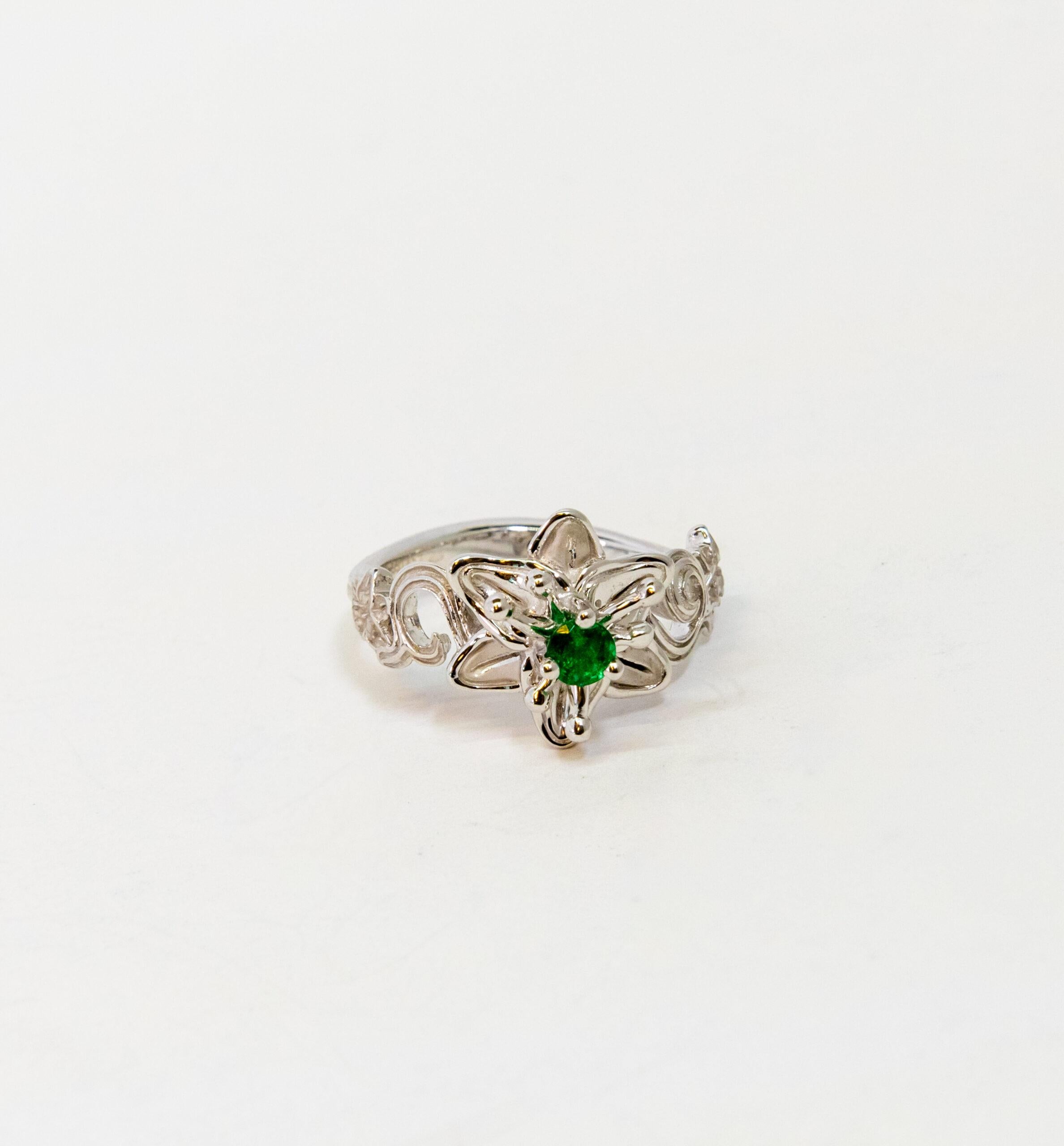 This ring is made of 18K White Gold. It is decorated as floral pattern with a round-cut Emerald (~0.21).

Size – 54.5 (7 US)