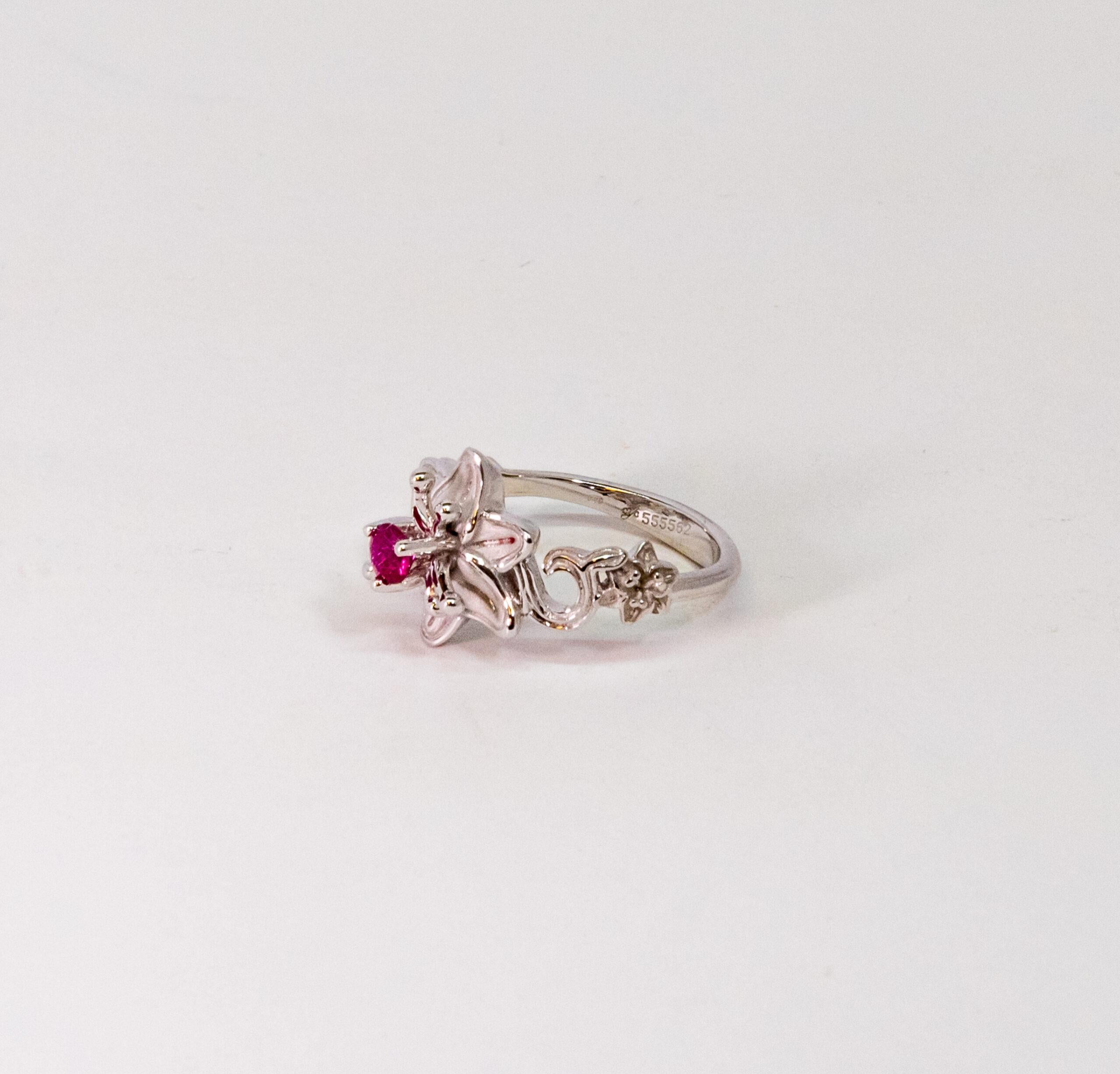 This ring is made of 18K White Gold. It is decorated as floral pattern with a round-cut Ruby (~0.28).

Size – 53.5 (6.5 US), 56 (7.5 US)