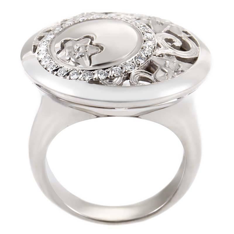 This whimsically designed cocktail ring is exceptionally beautiful and would look wonderful gracing any lady's hand. The ring is made of carved 18K white gold and is set with ~.22ct of diamonds.