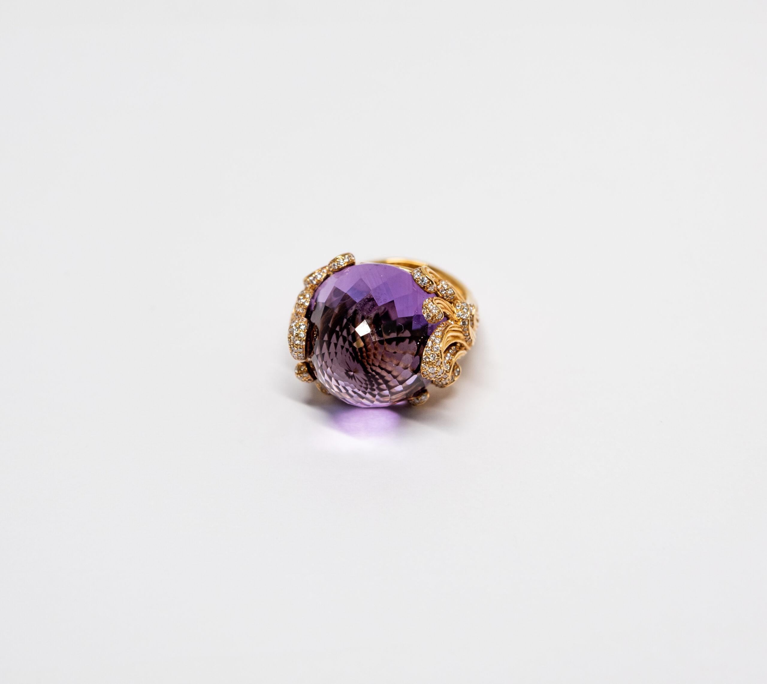 10068452 Carrera y Carrera
This ring is made of 18K Yellow Gold. The top of the ring is decorated with large Amethyst (~30.48ct). The sides of the ring are paved with diamonds (~0.84ct)

Size – 56 (7.5 US)