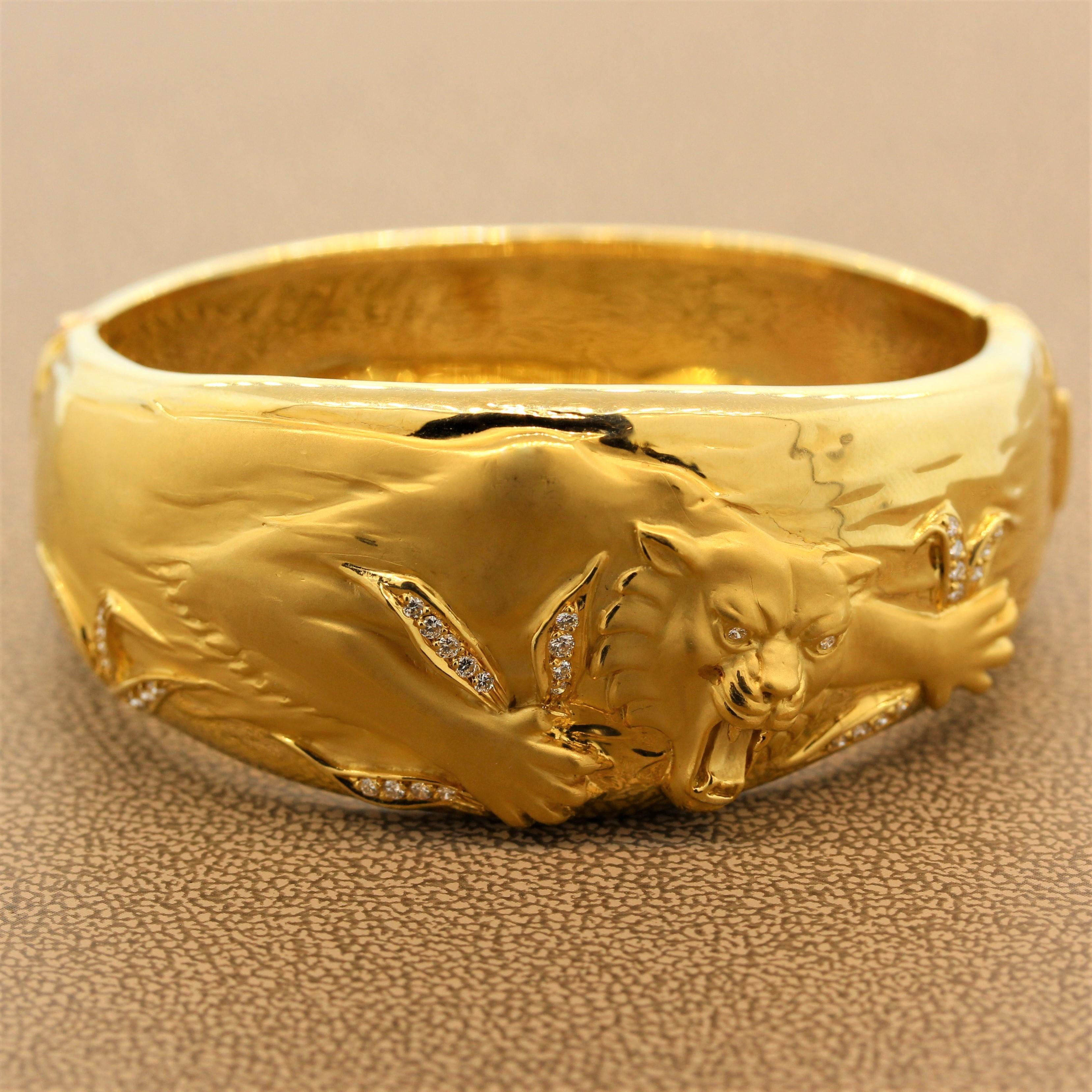 A fierce creation by Spanish jewelry house Carrera y Carrera. The bracelet depicts a strong panther leaping on the attack. It is complemented by diamond studded tall grass which branch across the bracelet. Made in 18K yellow gold this designer