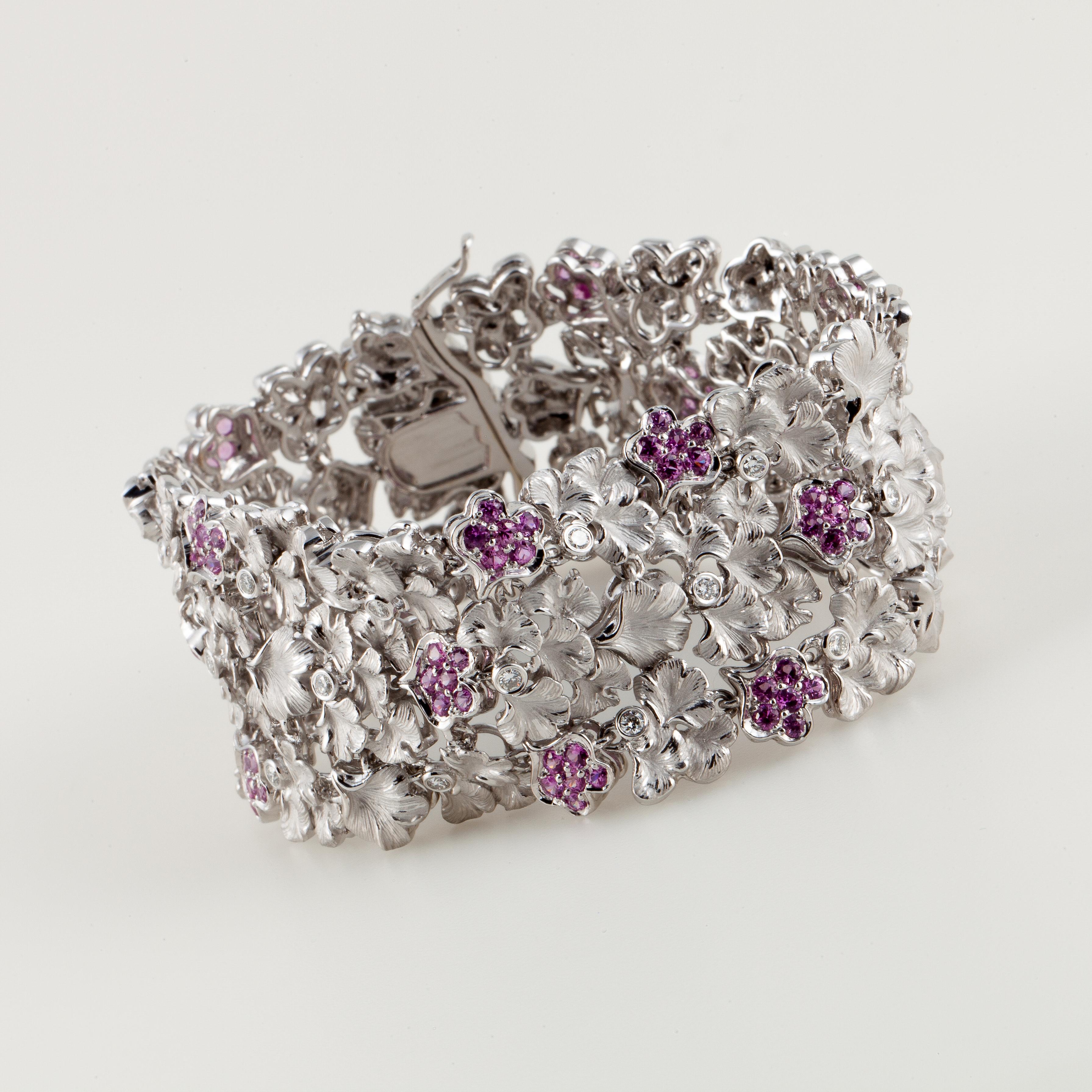 Carrera y Carrera floral bracelet in 18K white gold with pink sapphire and diamond accents.  The sapphires total 3.85 carats and 18 round diamonds that total .60 carats; G-H color and VVS clarity.  The bracelet measures 7 1/4 inches long and 1 1/16