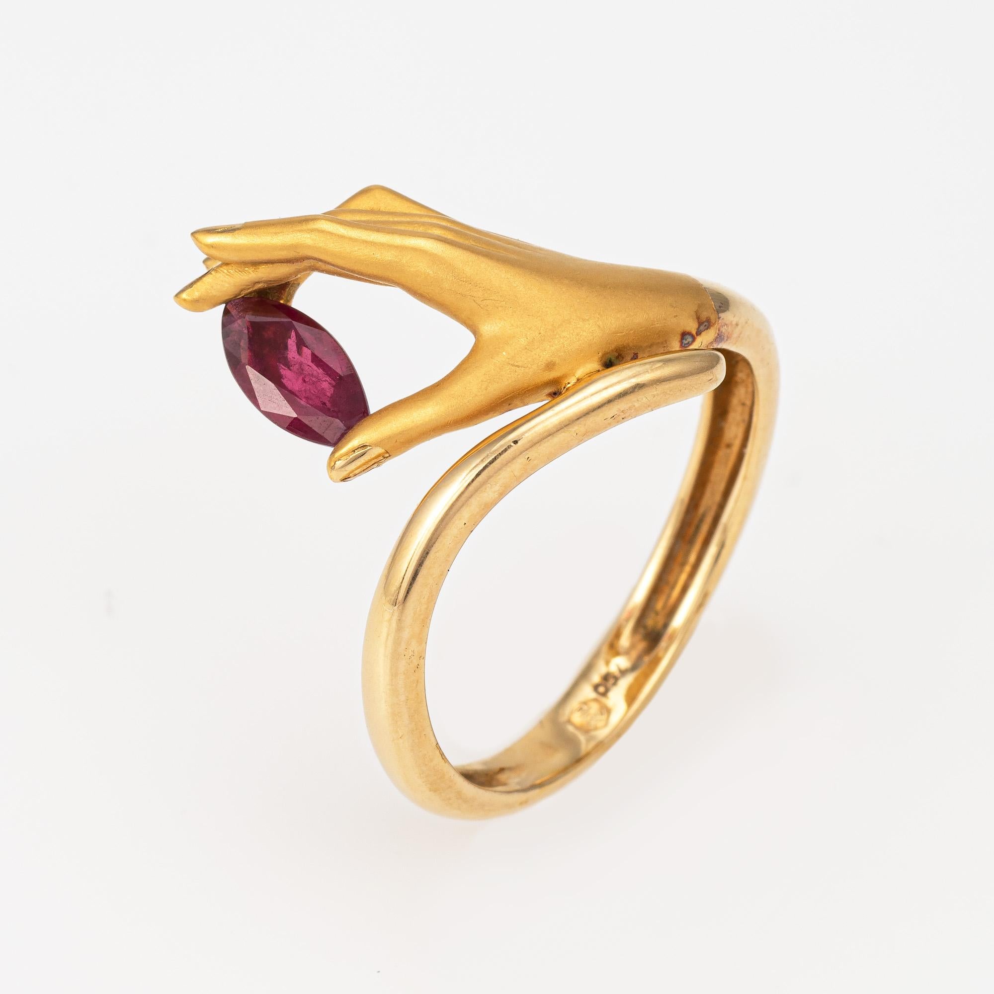 Estate Carrera y Carrera ruby hand ring crafted in 18 karat yellow gold.  

Marquise cut ruby measures 6mm x 3.5mm. The ruby is in very good condition and free of cracks or chips.

The beautifully detailed ring highlights an elegant hand in matte