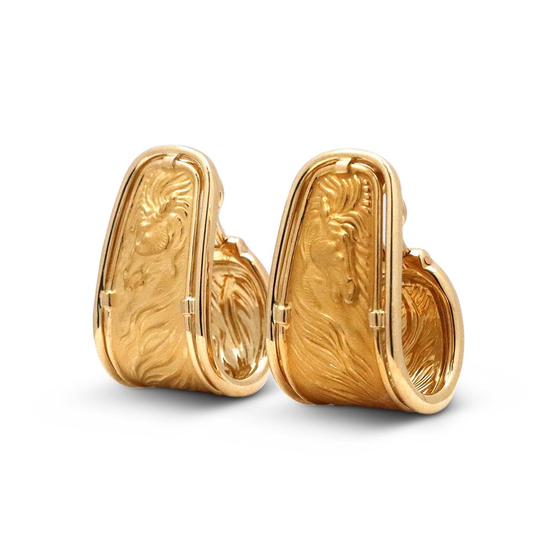 Authentic Carrera Y Carrera ear clips crafted in 18 karat yellow gold. The hoop earrings feature a repoussé matte gold horse with flowing mane. Stamped with Carrera Y Carrera maker's mark, 750. Clip backs for non-pierced ears. The earrings are not