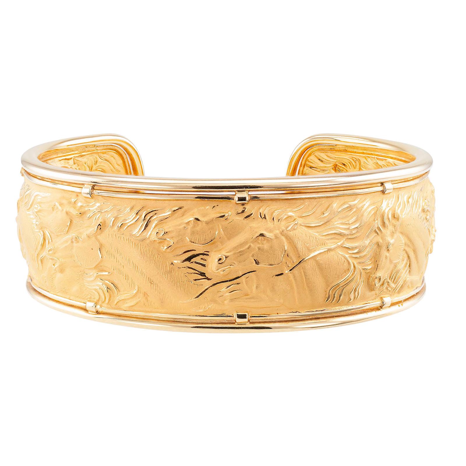 Carrera y Carrera yellow gold horse cuff bracelet.

DETAILS:
METAL: 18-karat yellow gold decorated by an equestrian theme in relief.

HALLMARKS: maker’s marks for Carrera y Carrera, numbered 170483.

MEASUREMENTS: approximately 7/8” (16 mm) wide,