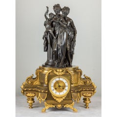 Pendule de cheminée figurative Napoléon III en bronze doré et patiné Carrier-Belleuse