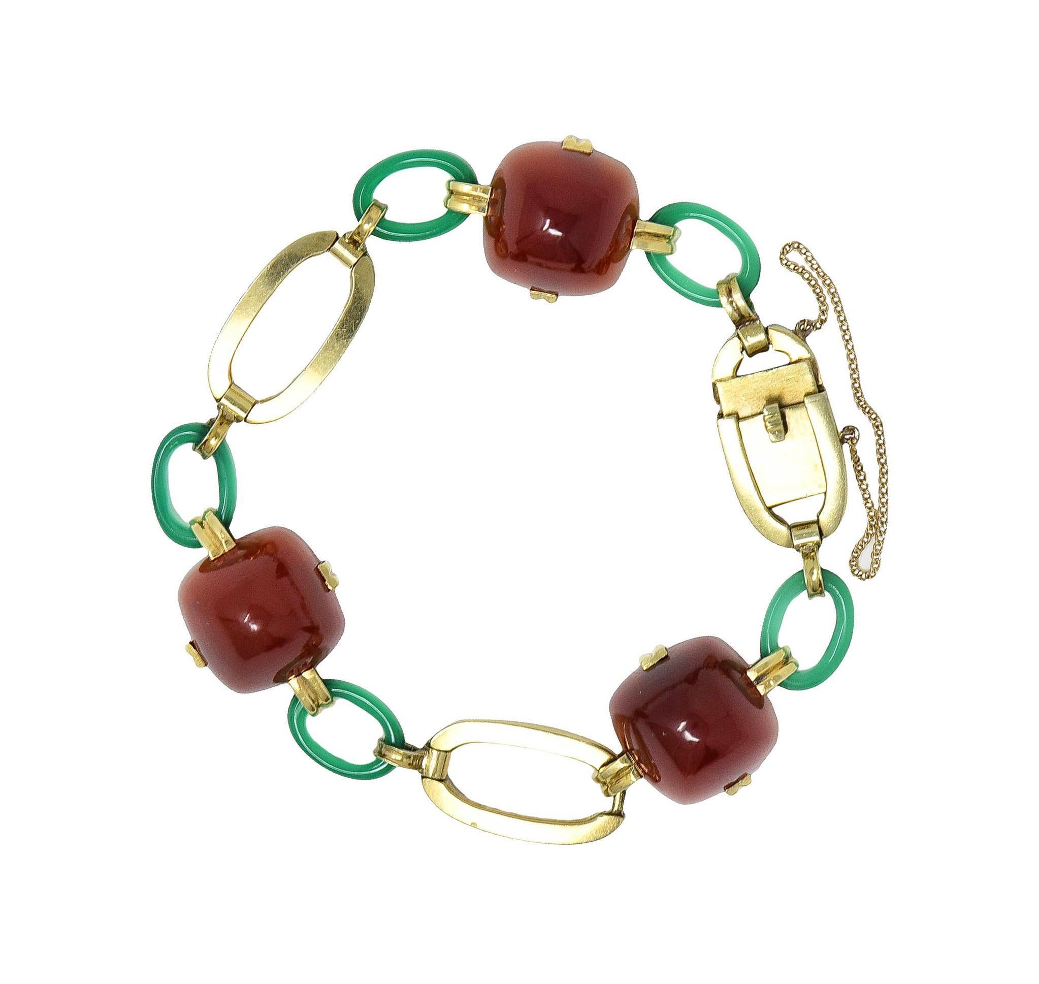 Bracelet is comprised of gold oval, carved carnelian, and carved chrysoprase links 
Carnelian links are sugarloaf-shaped cabochons measuring 14.0 x 14.0 mm 
Translucent orangey red in color and set with grooved prongs 
Chrysoprase is carved as oval