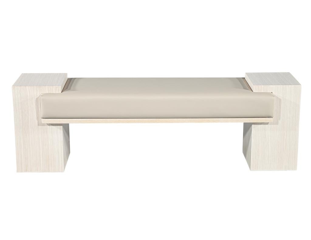 Add a touch of understated elegance to your entryway with this newly handcrafted modern bench by Carrocel. Featuring a clean and sleek design, the bench showcases striking oak column pedestals and trim in a sophisticated bleached white oak finish.