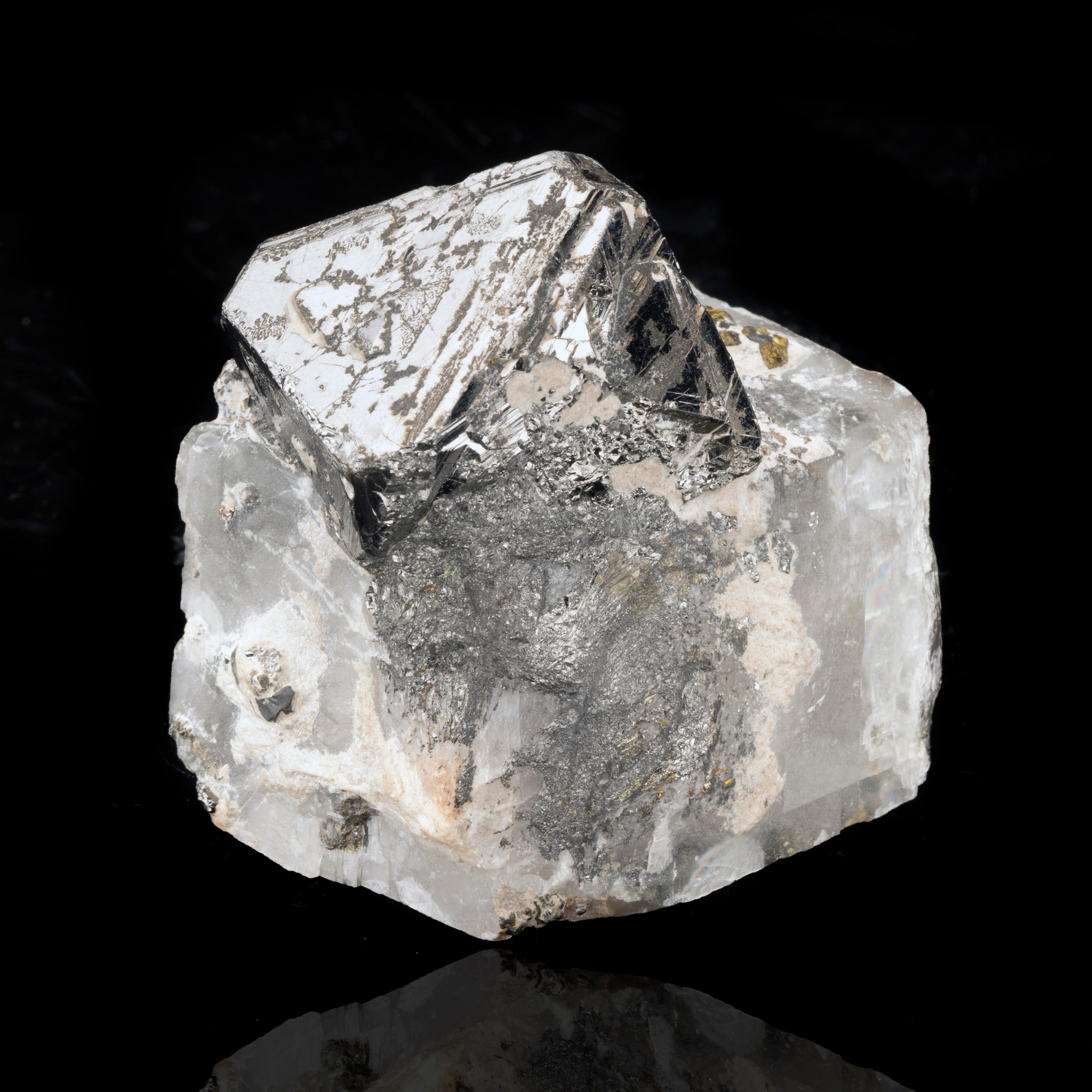 This combination specimen from the DRC features a metallic etched, octahedral carrollite on a fascinating matrix comprised almost entirely of a single calcite crystal growing in a rhombohedral habit with four whole faces showing zero evidence of any