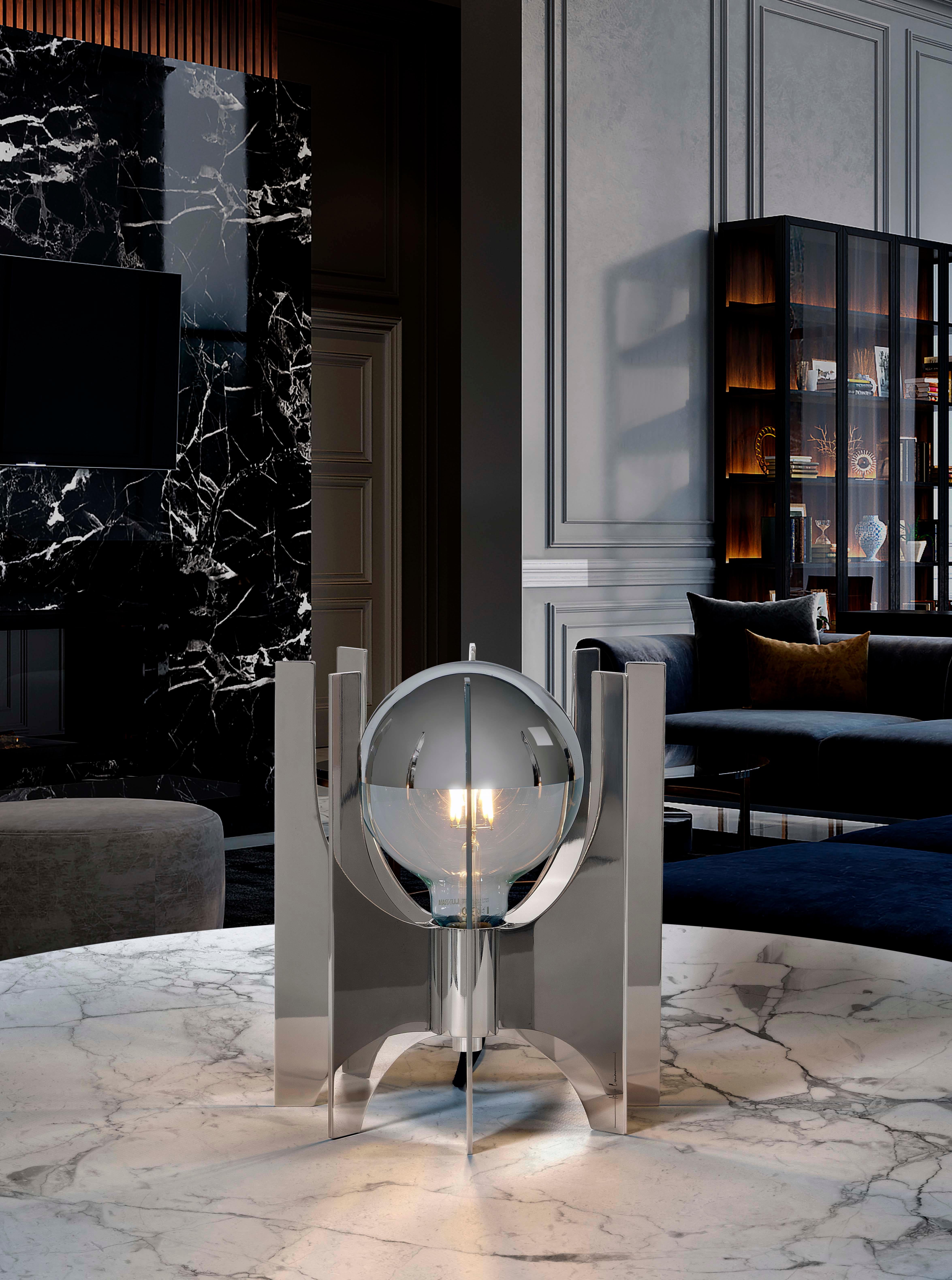 Carrousel is a table lamp developed through the repetition of a single part, the stainless steel tab that surrounds the loose base of the surface and which is inspired by the typical adornments of Art Déco buildings. 

With hand polishing and each