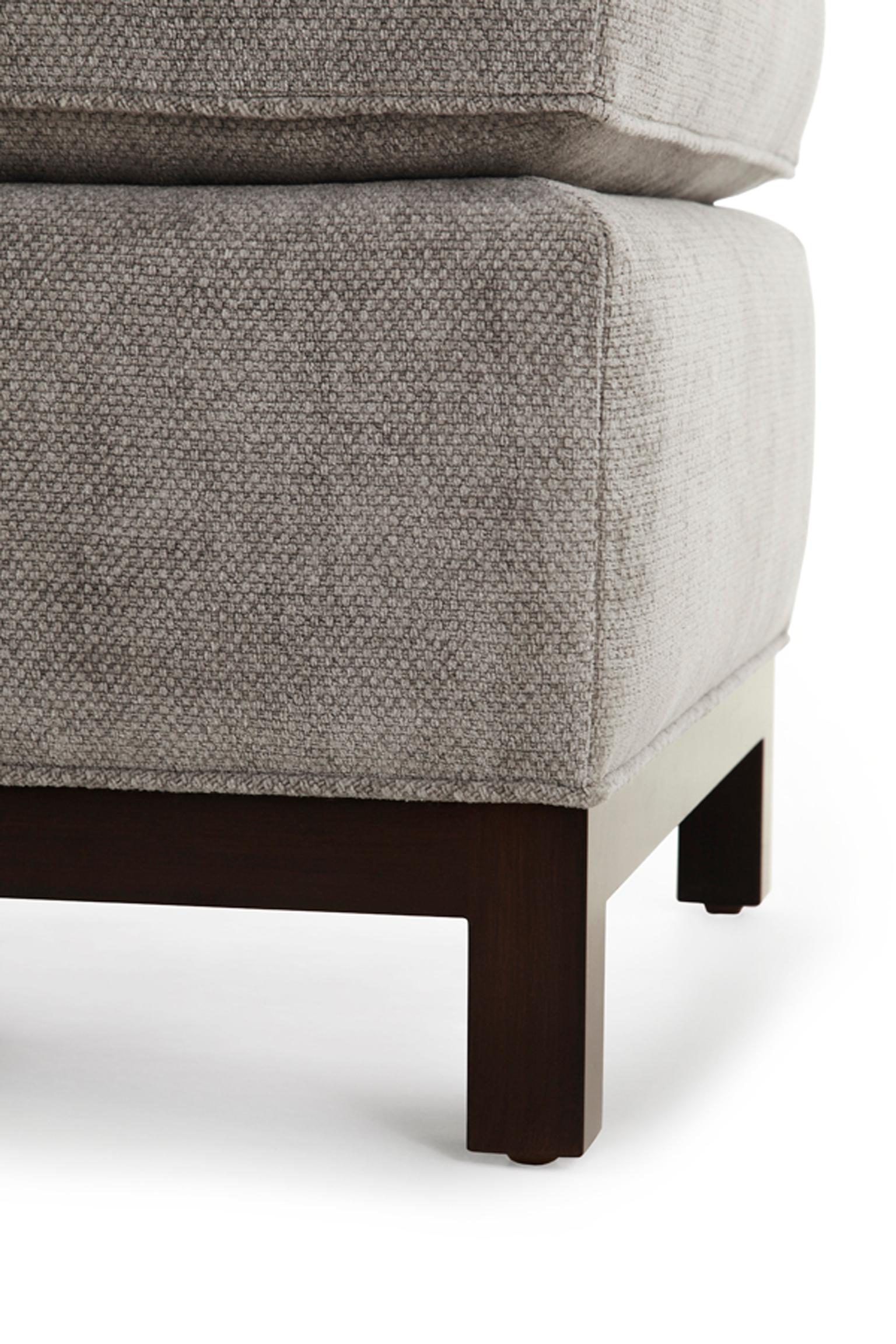 The simple Carson ottoman strikes a perfect balance of modern clean lines and traditional details. It features a slight pull, piped details, semi-attached seat cushion, spring edge, and an exposed wood base.