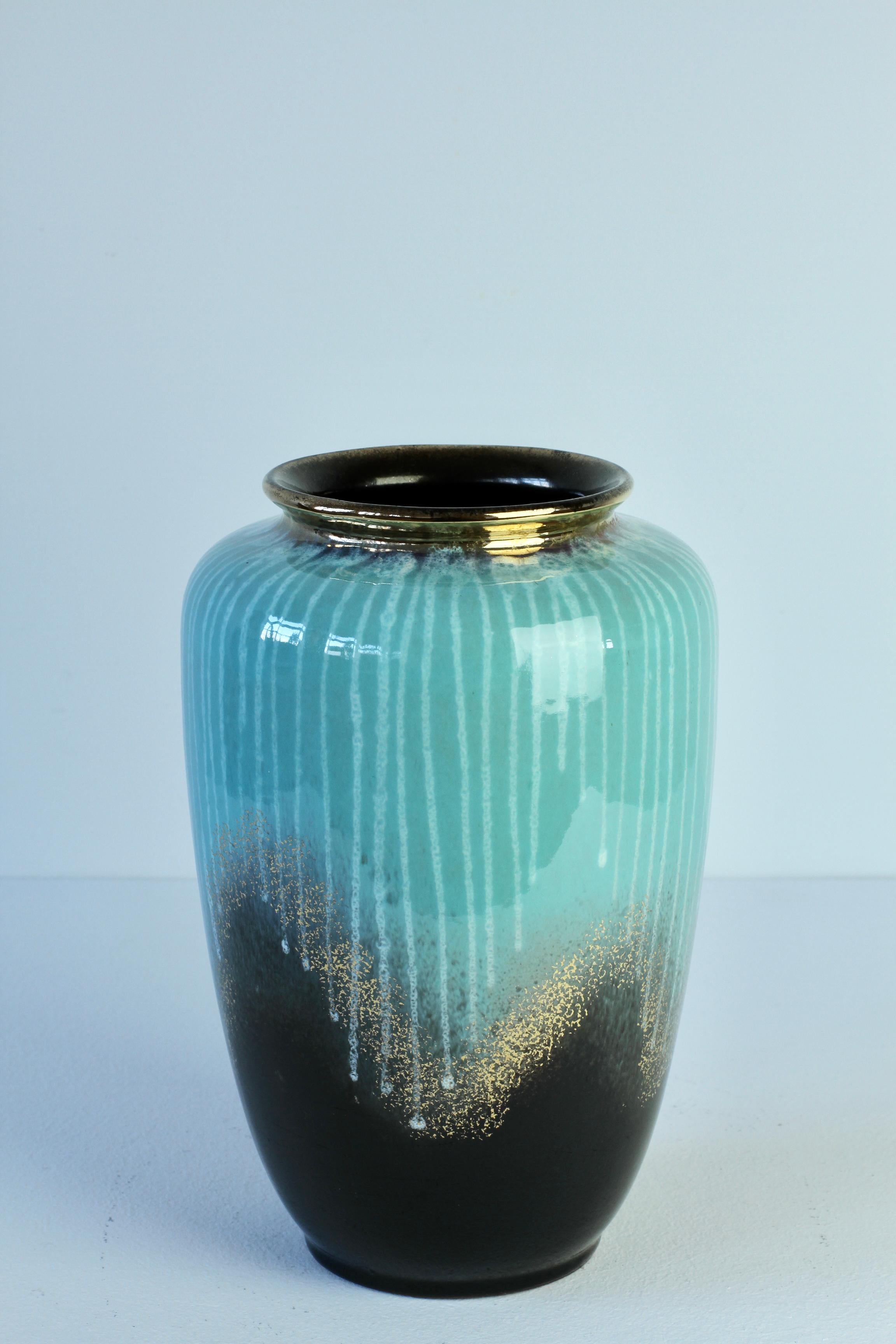 Beautiful vintage midcentury West German vessel or vase by Carstens Tonnieshof made post war circa 1950s with a turquoise blue and black glaze with gold details and white lines of drip glaze. Perfect to have a pair for over the mantlepiece of a