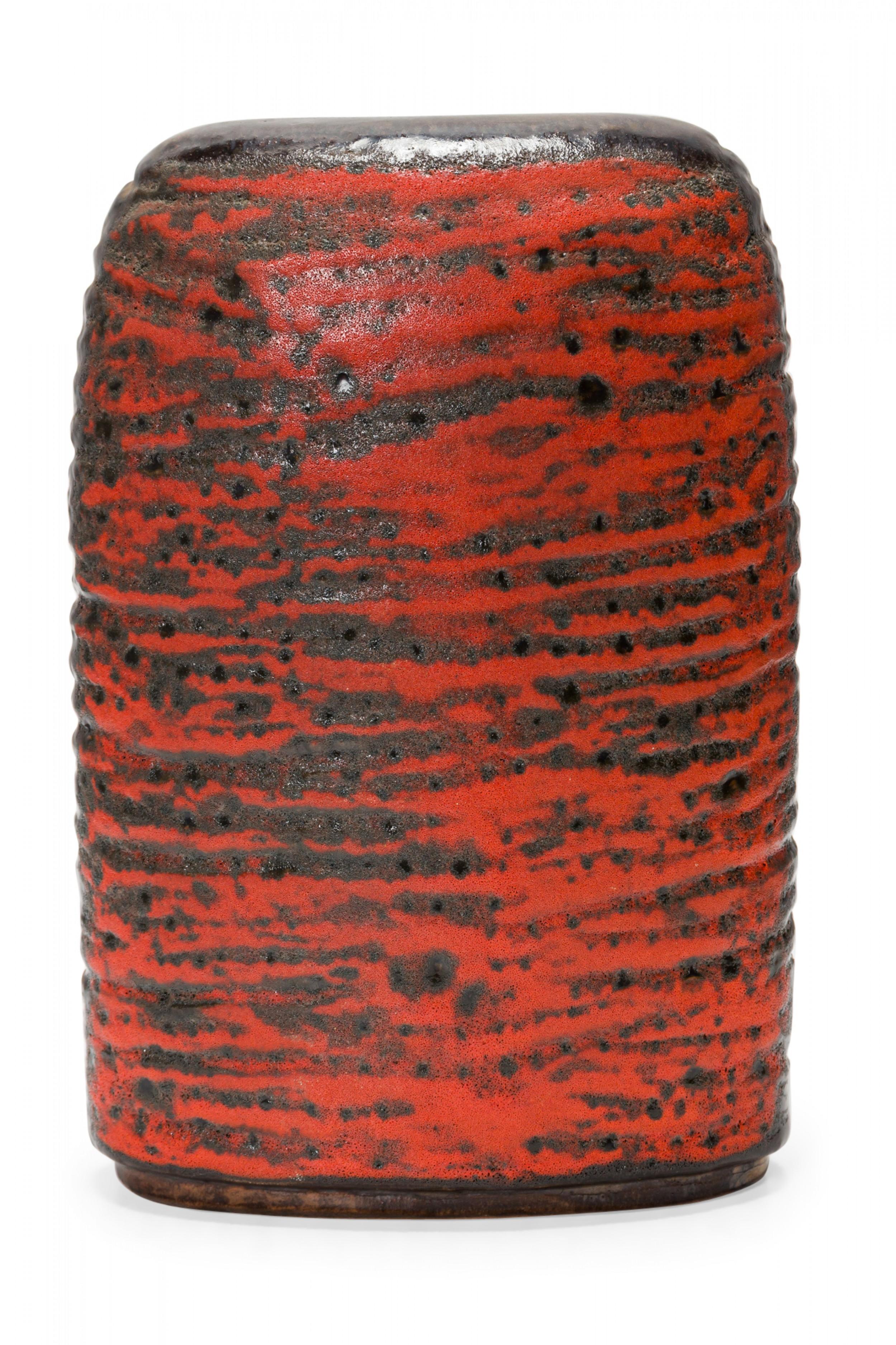 West German mid-century two-lobed form ceramic vasew with an abstract striped orange and black fat lava glaze. (mark on bottom for CARSTENS OF TÖNNIESHOF, W. GERMANY 0563-23).
     