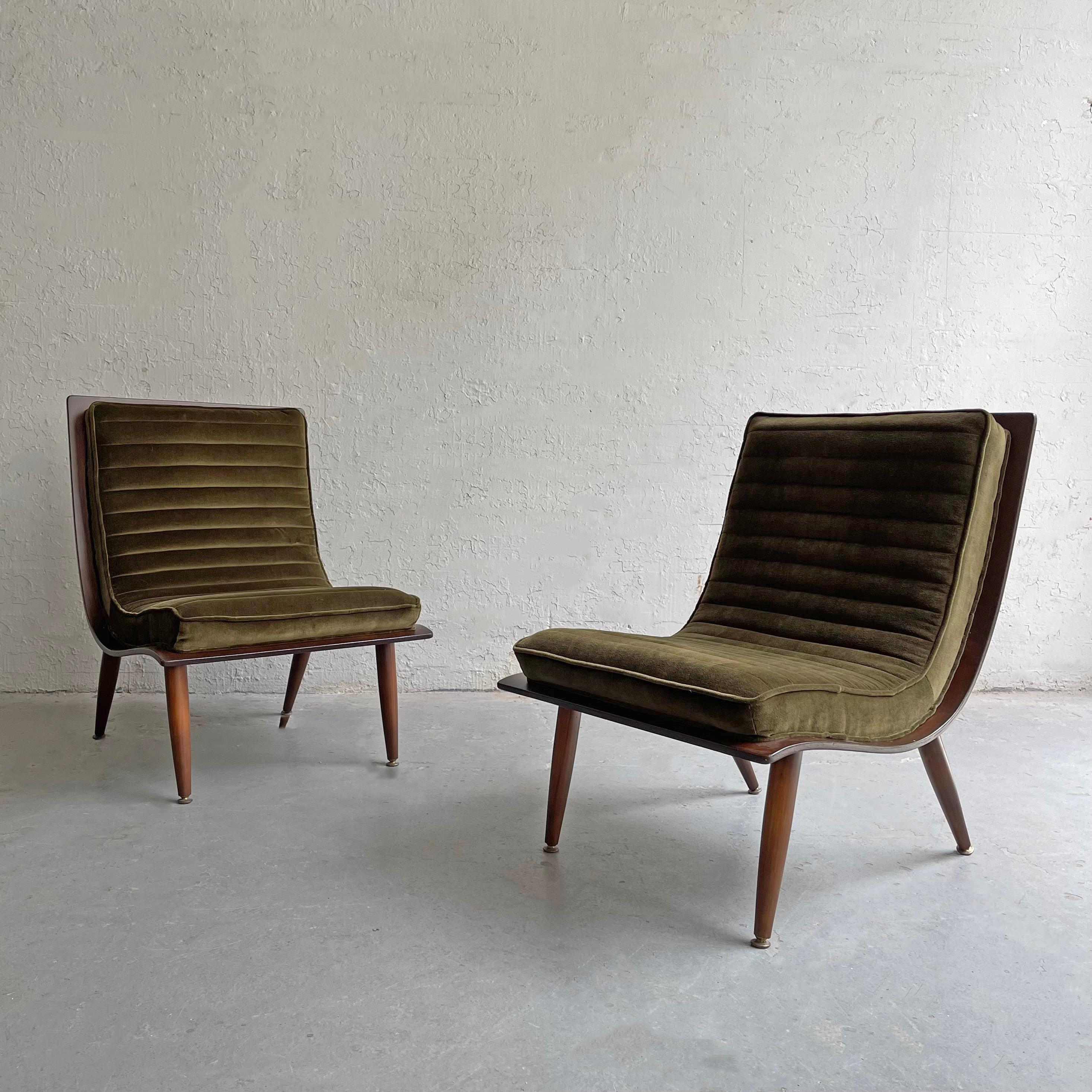Pair of Mid-Century Modern, scoop slipper lounge chairs by Carter Brothers feature walnut bentwood frames with brass tipped tapered legs and rolled green velvet upholstery.
