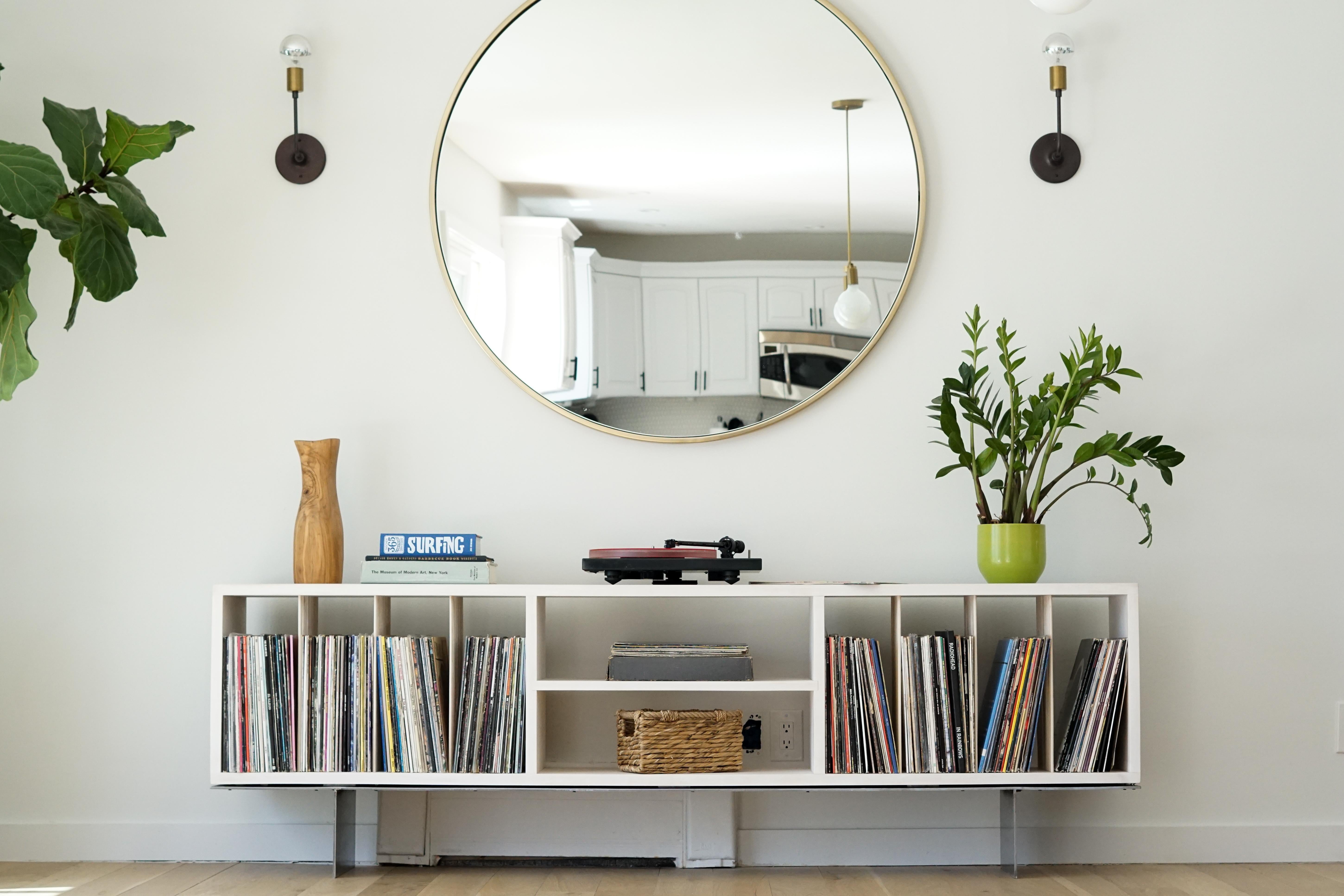 Custom modern bleached maple storage case to house a vinyl record collection of over 400 records. 

This piece is floating on top a custom designed steel base and features maple dowel dividers and a fixed middle shelf. 

 