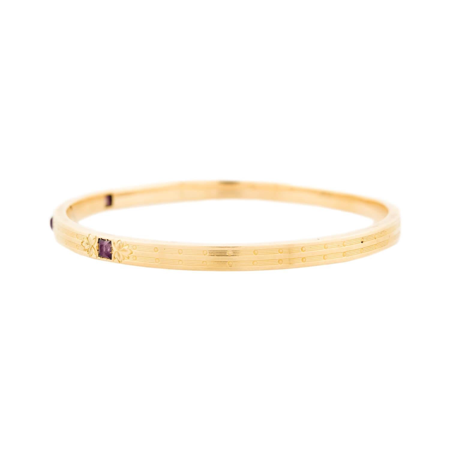 A beautiful gold and amethyst bangle bracelet from the Edwardian (ca1910s) era! This stunning 14k bangle features 3 square cut amethyst stones, which are held in place by 8-pronged settings. The amethyst stones create a lovely contrast to the gold
