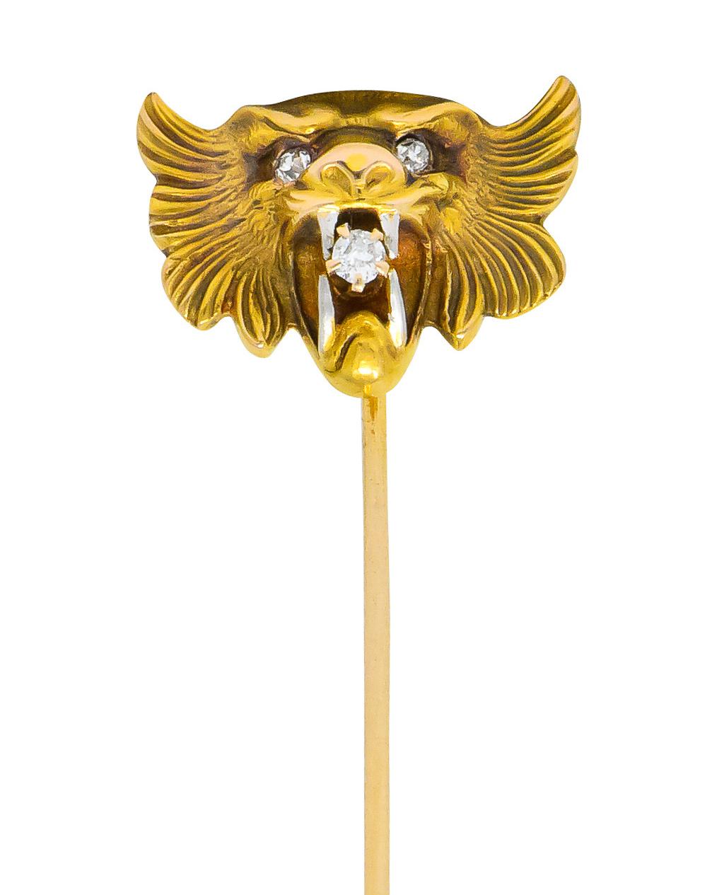 Designed as a gold stylized tiger's face with an open mouth bearing white gold fangs clutching a claw set transitional cut diamond, eye-clean and white

With single cut diamond eyes

Partial maker's mark for Carter Gough & Co. and stamped 14k for 14