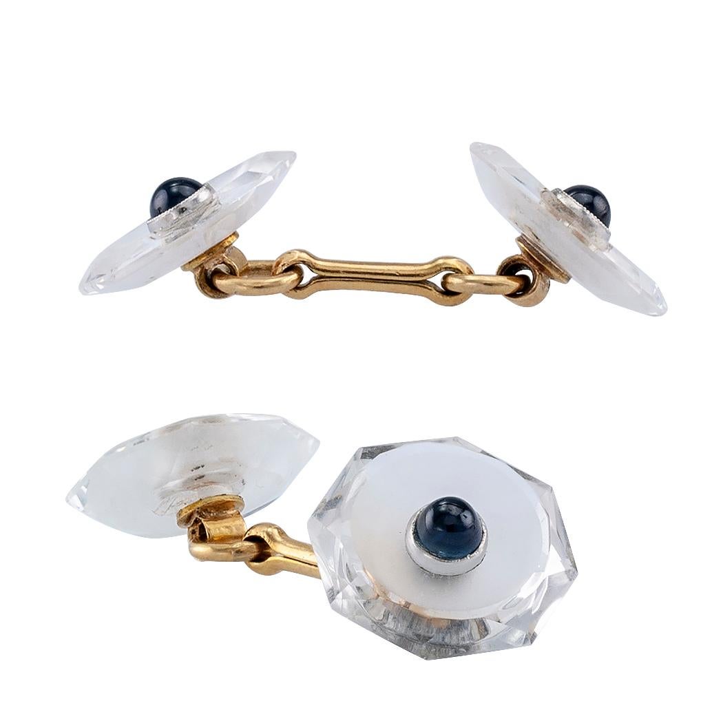 Carter Gough & Co Art Deco rock crystal sapphire and gold gentleman’s dress set circa 1930. Comprising a pair of double faced, faceted and frosted rock crystal cufflinks and four shirt studs, each centering a bezel-set, cabochon, blue sapphire,