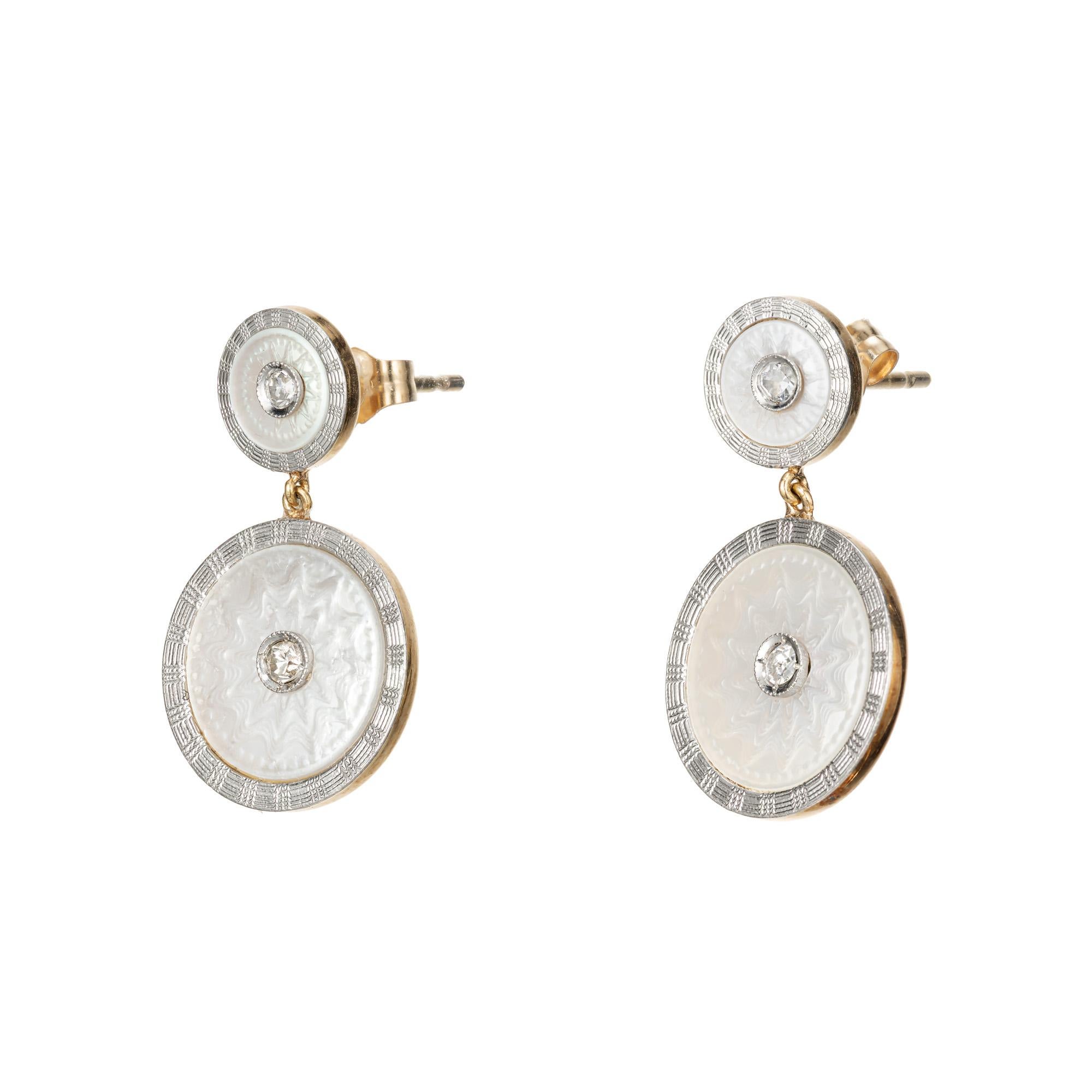Early 1900's Beautifully crafted, Carter Gough & Co Platinum, 14k yellow and white gold carved Mother of Pearl dangle earrings. 4 bezel set diamonds set in exquisitely carved Mother of pearl discs, each patterned rims. These unique dangles contain 3
