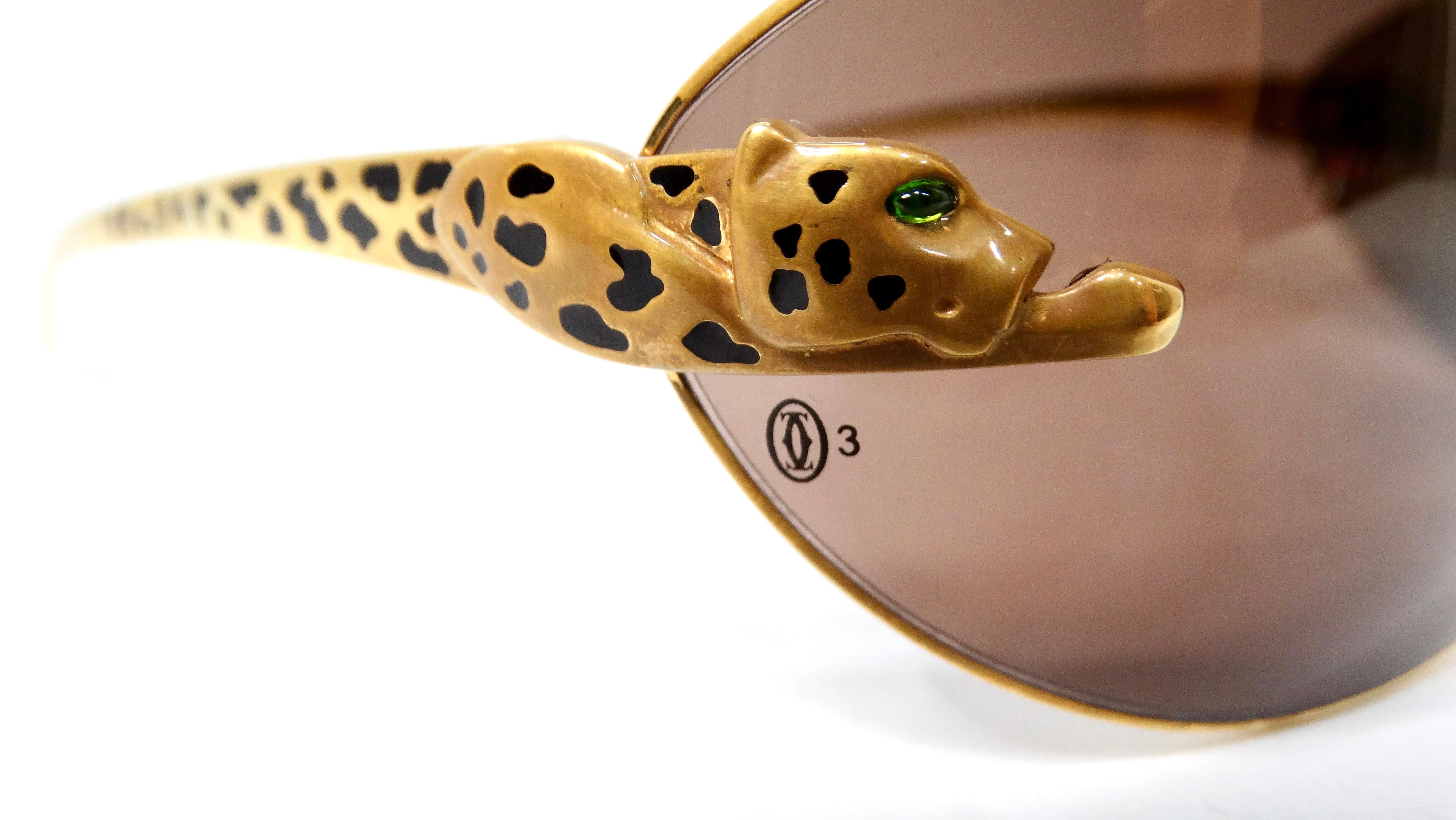 Introducing the exquisite Carter Panthere Rare Limited Series Sunglasses, a true testament to luxury eyewear. These stunning gold-tone sunglasses feature a striking shield shape that seamlessly blends fashion with function. The distinctive running