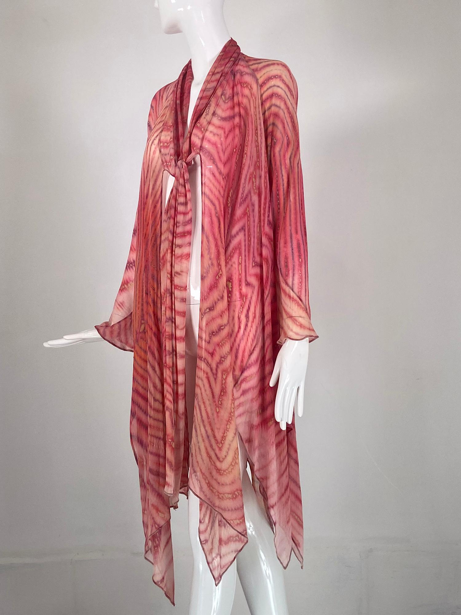 Carter Smith silk crepe shibori (tie dye) bias cut tie front coat. Open front coat of silk crepe dyed in pinks, purple and cream, perfect for layering. Bias cut the coat has long raglan sleeves, bias panels with pointed hemline. Long ties at the