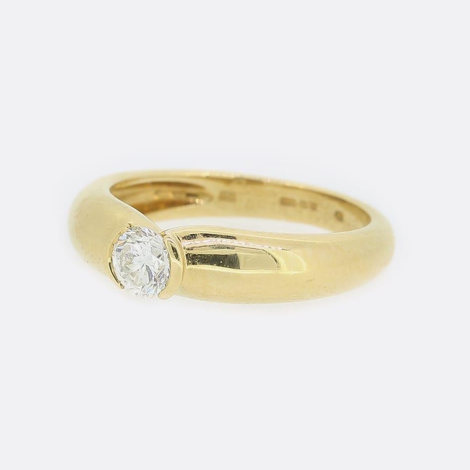 This is an 18ct yellow gold diamond solitaire ring from the luxury jewellery designer Cartier. The ring forms part of the 1995 collection and plays host to a half bezel set 0.30 carat round brilliant cut diamond.

Condition: Used (Very Good)
Weight: