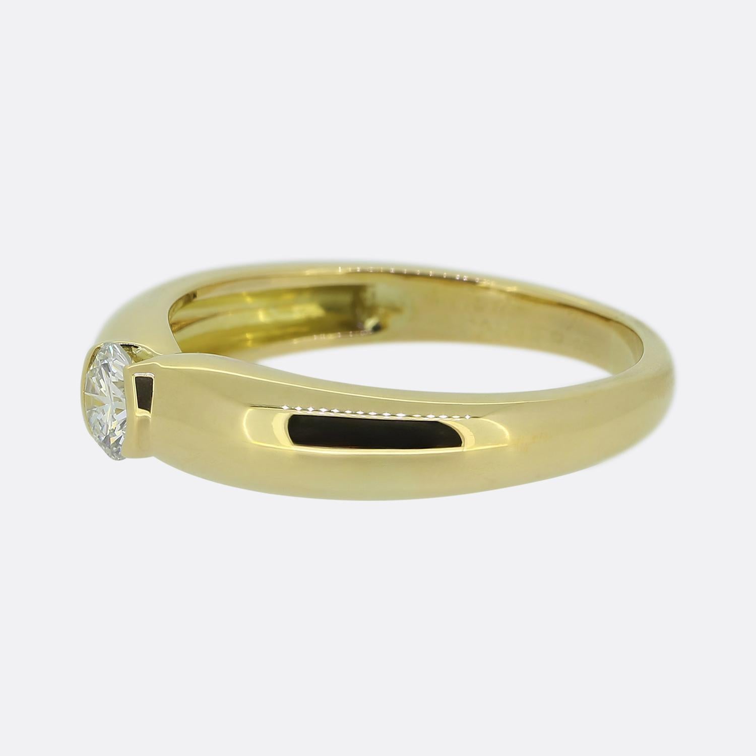Here we have a subtle yet stylish diamond solitaire ring from the world renowned luxury jewellery house of Cartier. The design features a single round brilliant-cut diamond which has been securely semi-bezel set at the centre of the face. This lone