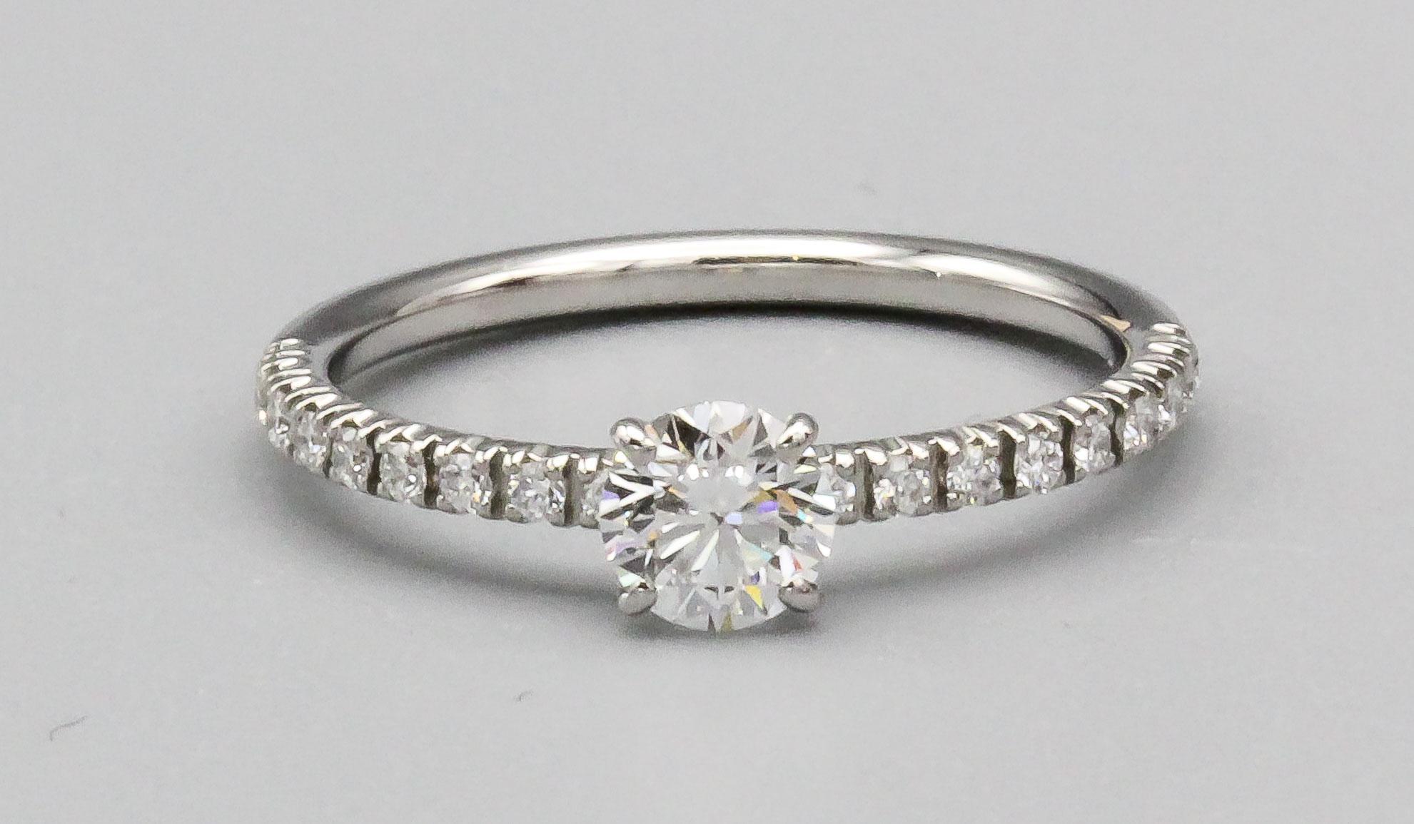 This fine Cartier diamond and platinum engagement ring is a beautiful and timeless piece of jewelry designed by the luxury brand Cartier. This stunning engagement ring features a high-quality diamond that has been certified by the Gemological