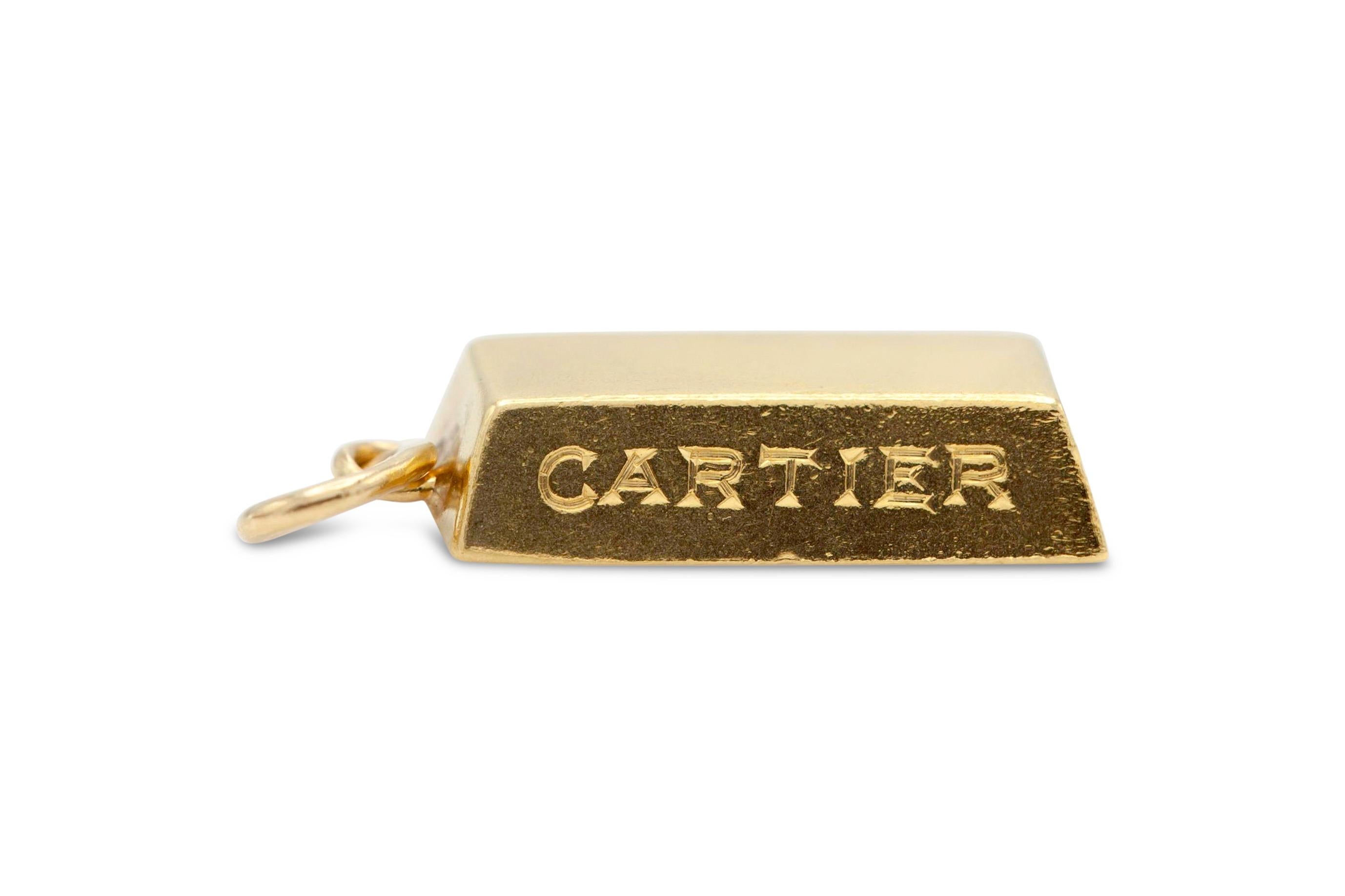 18K yellow gold bar weighing 1/4oz, wearable as a pendant. Signed Cartier. 