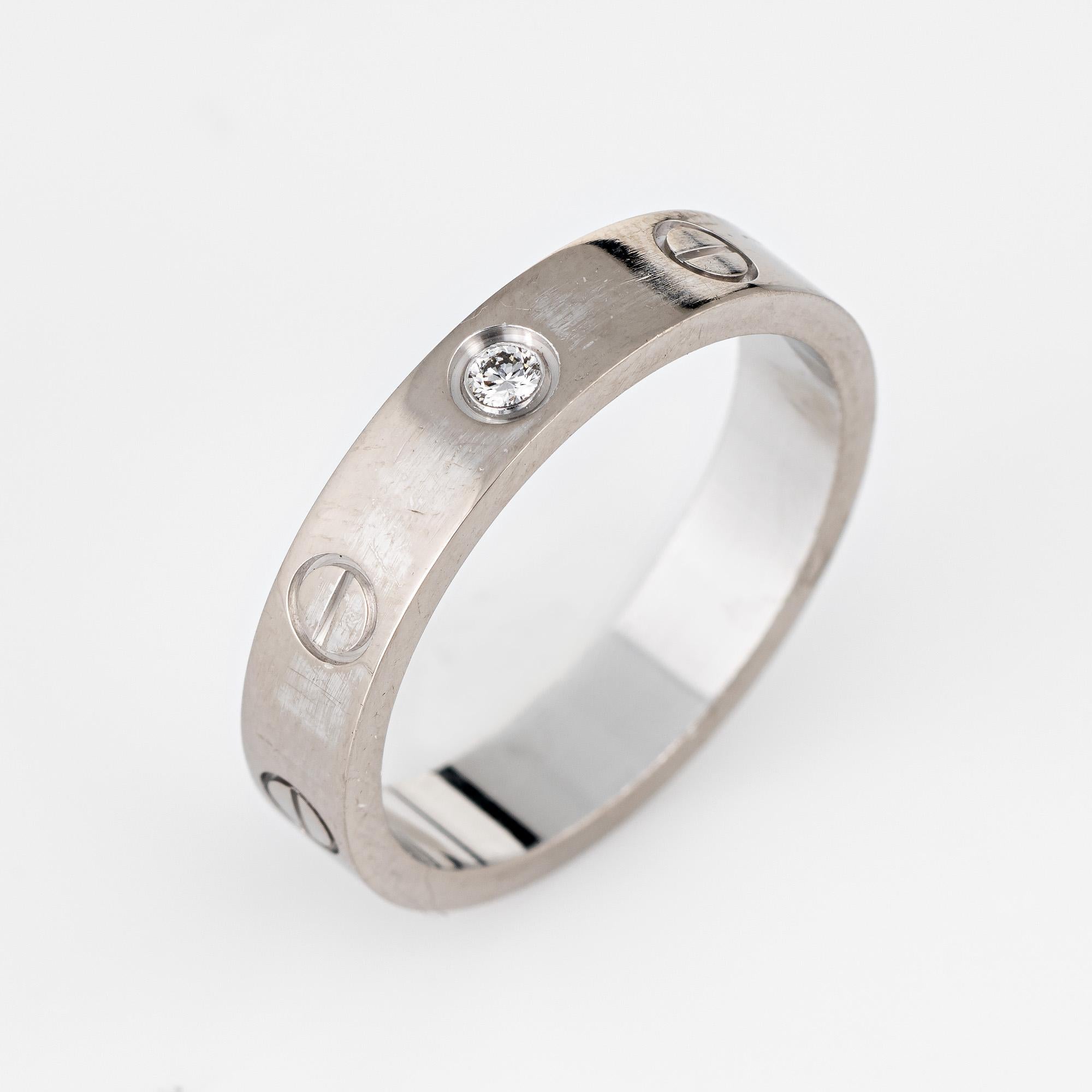 Cartier 1 diamond love wedding band crafted in 18 karat white gold.  

One 0.02 carat diamond is set into the band (estimated at F-G color and VVS2 clarity).

The ring currently retails for $2,160 (plus taxes).

The ring is in excellent condition