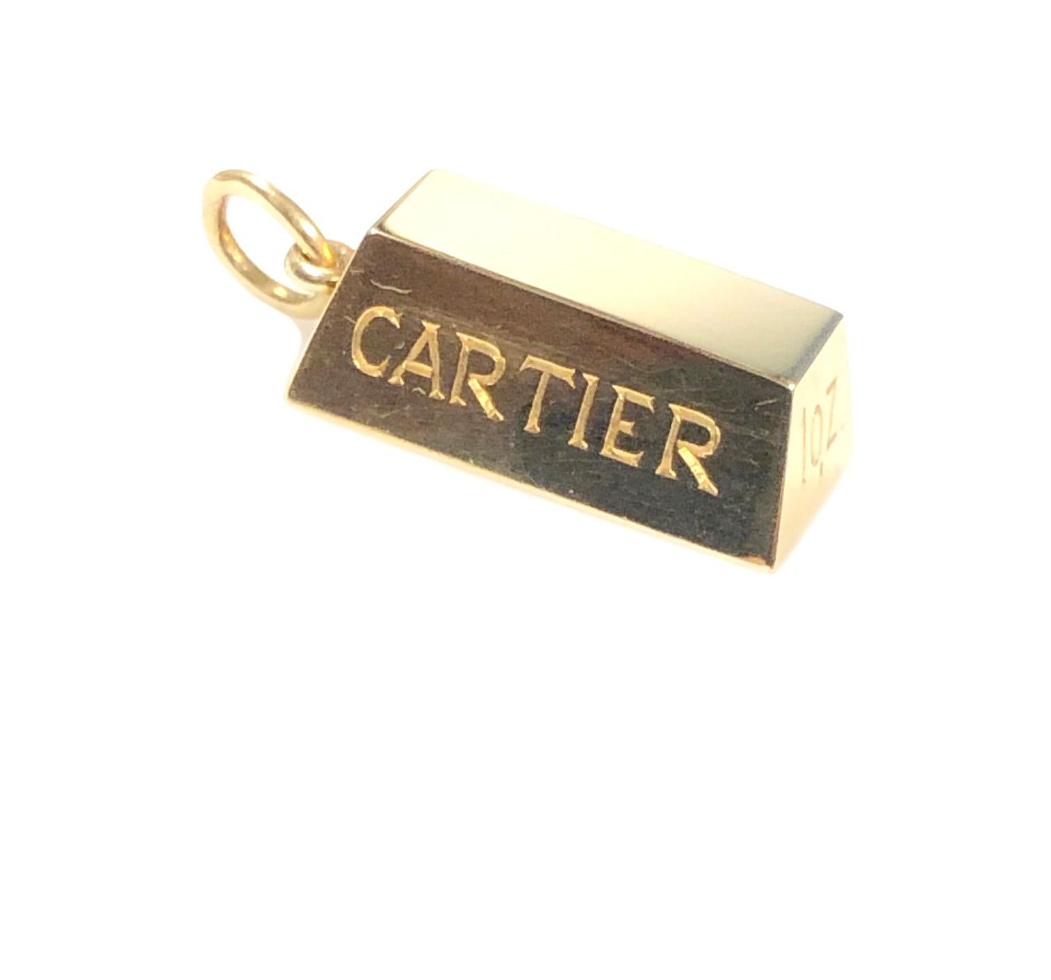 Circa 1970s Cartier 18k Yellow Gold 1 ounce Ingot Pendant. Measuring 1 inch in length, this unique piece is new, never worn and comes in the original Cartier Pouch and box