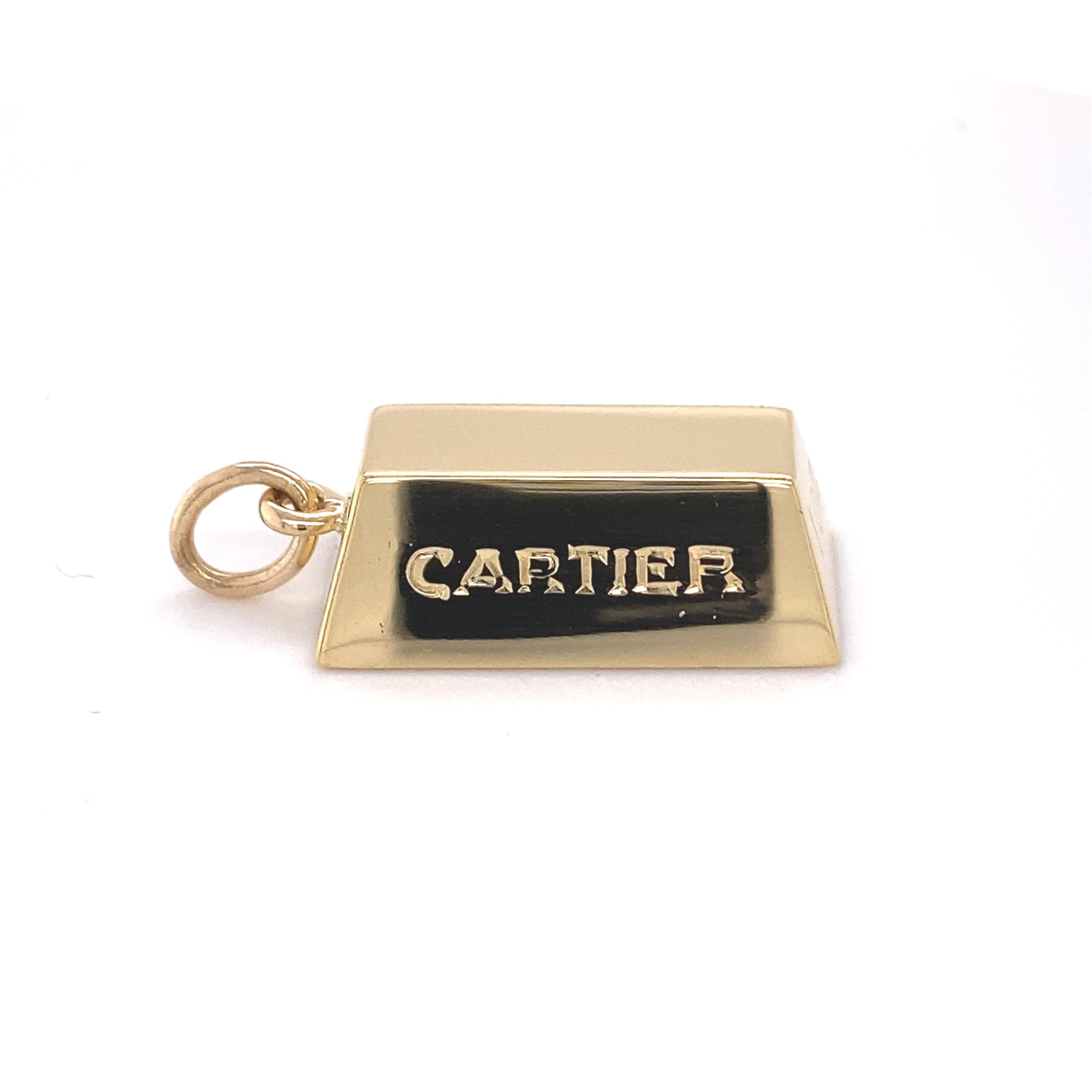 Cartier Vintage Ingot Gold BAr Pendant Charm
Style:  Pendant Charm
Metal:  18kt Yellow Gold
Size - Measurements:  1 Inch - 1.25 inch with Bail / 1/2 inch Wide 
Hallmark:  CARTIER 1 OZ © Cartier 18K
Includes:  Elegant Jewelry