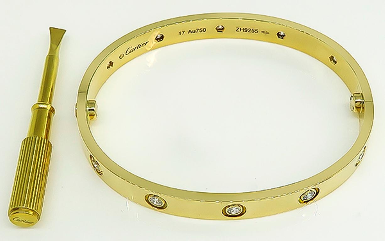 This amazing 18k yellow gold love bangle by Cartier is set with 10 sparkling round cut diamonds that weigh approximately 0.95ct. The bangle is size 17 and weighs 31.3 grams. It is signed Cartier 17 Au750 ZH9255 and comes with a