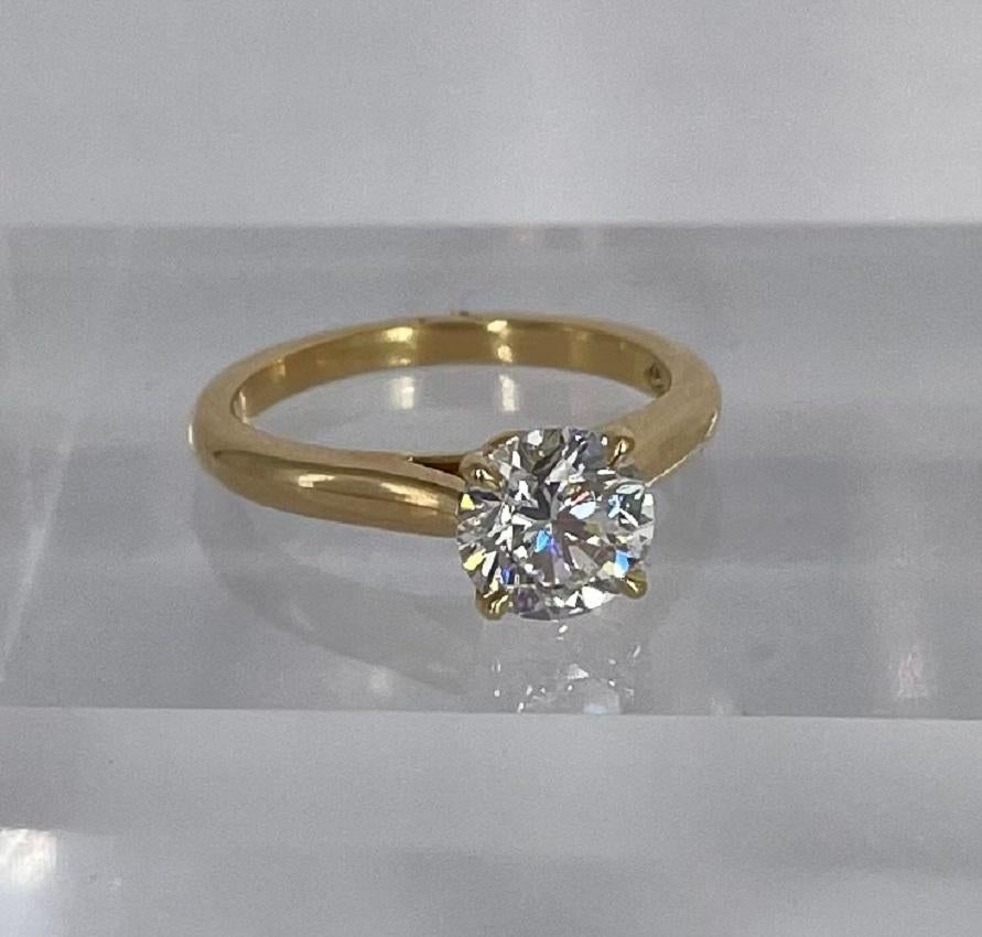 This bright and beautiful round diamond engagement ring by Cartier is perfectly timeless with a modern twist. Cartier's Solitaire 1895 in rose gold is a feminine and unique way to wear the classic solitaire. The diamond is exceptionally sparkly and