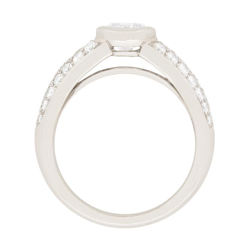 This stunning Cartier engagement ring features a 1.00 carat diamond surrounded by a pave diamond shoulders. The centre stone is excellent quality, with an F colour grade and VVS2 clarity grade. It is rub over set in 18 carat white gold. The