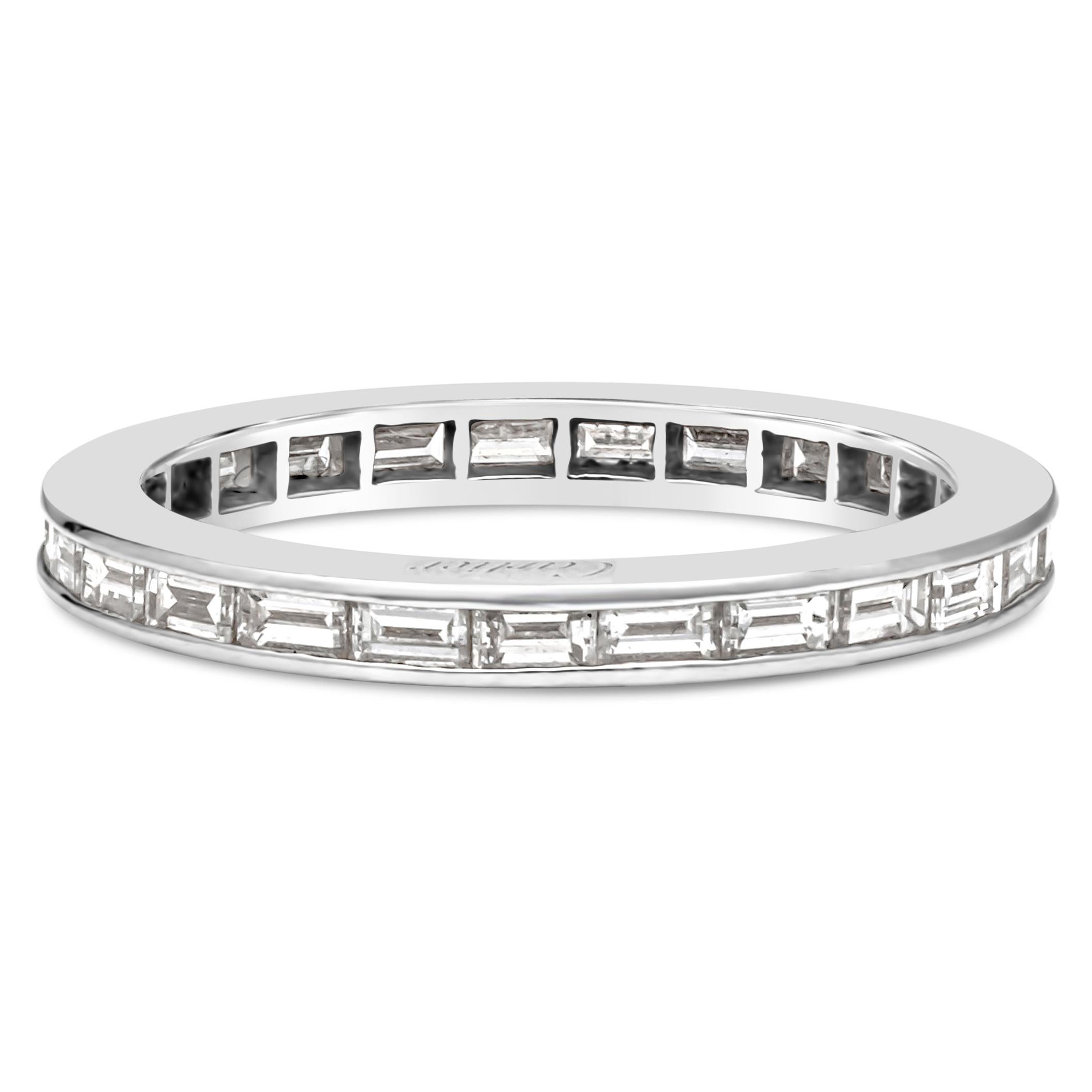 A beautiful eternity wedding band by Cartier, showcasing a row of 25 baguette cut diamonds weighing 1.02 carats total with approximately D-E color and VVS clarity, channel set on platinum. Signed by Cartier. Size 7 US. Comes with original box.