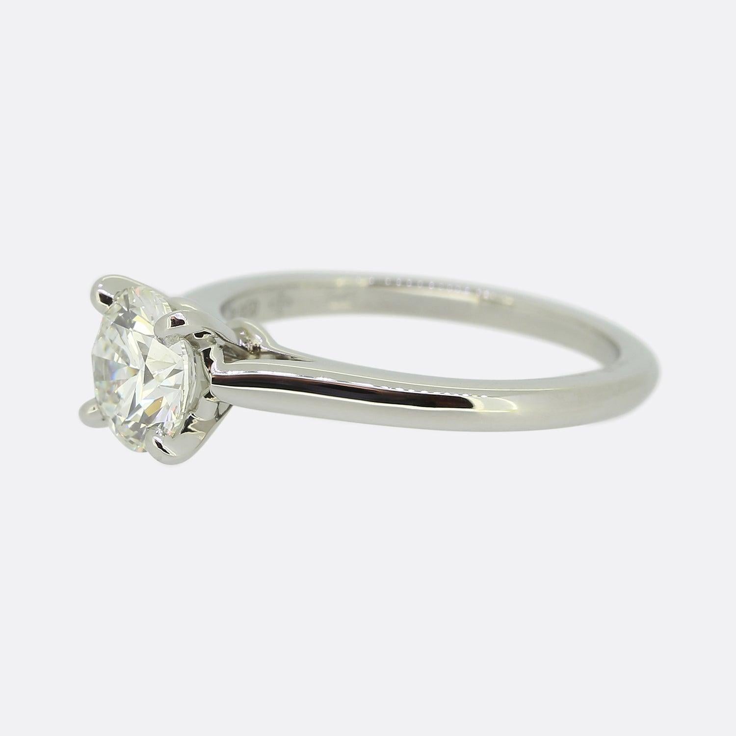 Ecco un classico anello di fidanzamento con solitario di diamanti della rinomata casa di gioielli Cartier. Un meraviglioso diamante rotondo taglio brillante da 1,03 carati si trova da solo e orgoglioso in un'incastonatura a quattro griffe in cima a