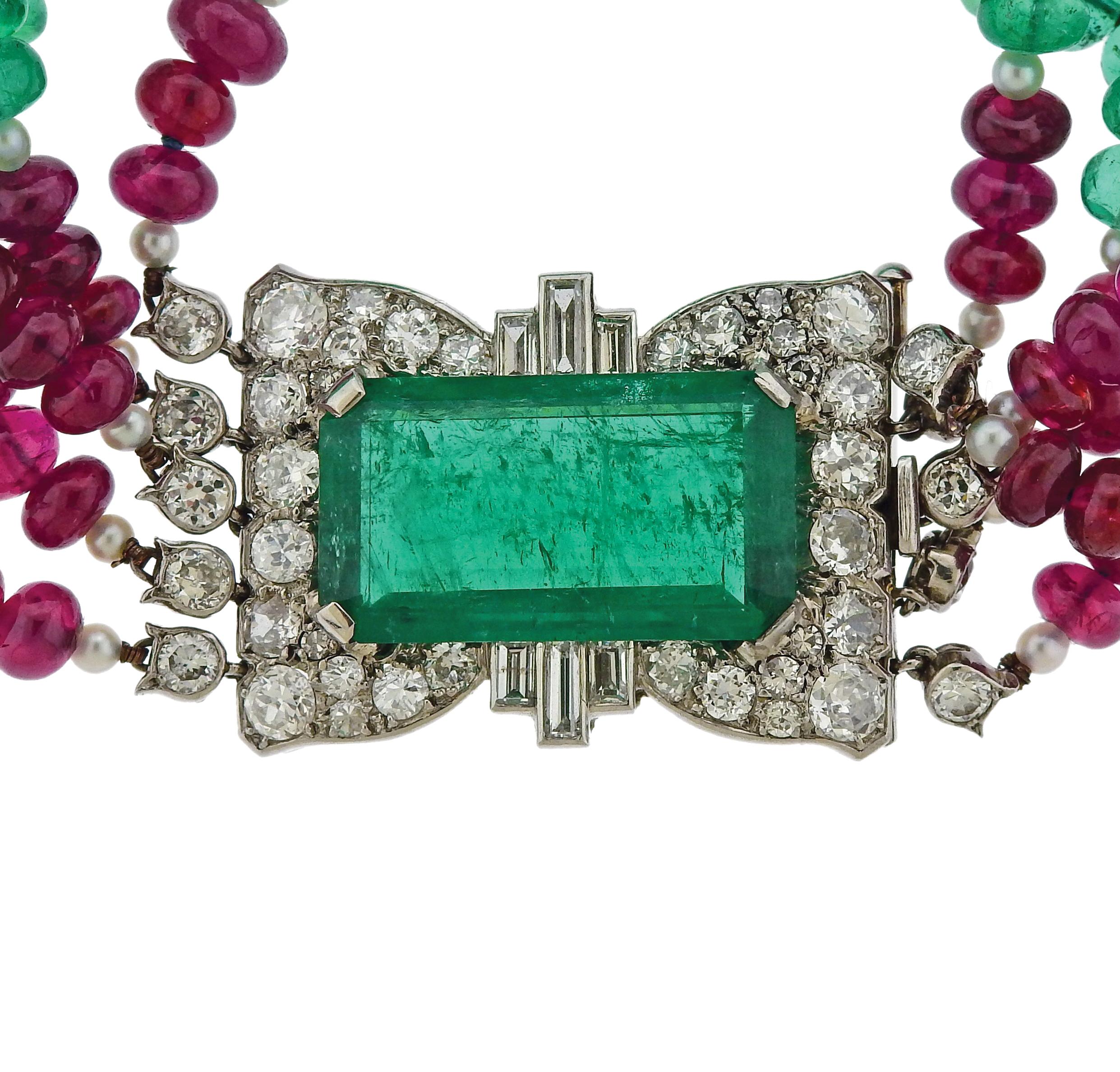 Important Cartier London platinum multistrand bracelet, set with 4.6mm to 6.8mm ruby and emerald beads, pears, and a 10.50ct emerald cut emerald, measuring 21.6mm x 12.2mm x 6mm, surrounded with approx. 3.30ctw in diamonds. The bracelet is 7
