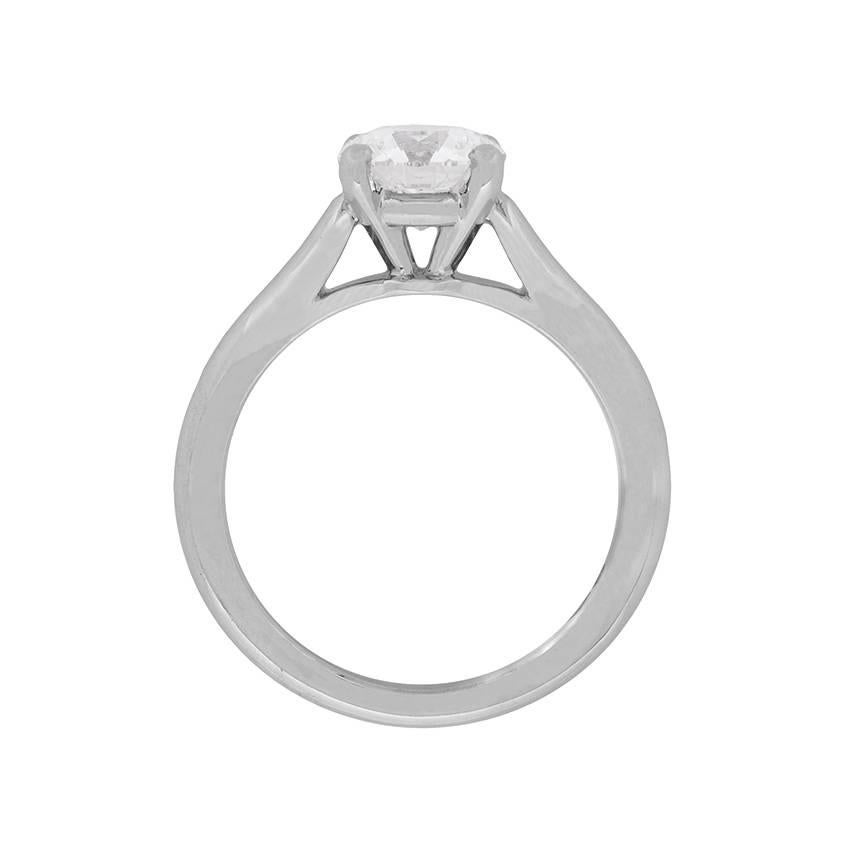 This elegant diamond solitaire ring is presented to us by Cartier. It features a stunning single diamond within a four claw setting. The basket features a strip of platinum to help support the stone, which leads into the platinum band. The diamond