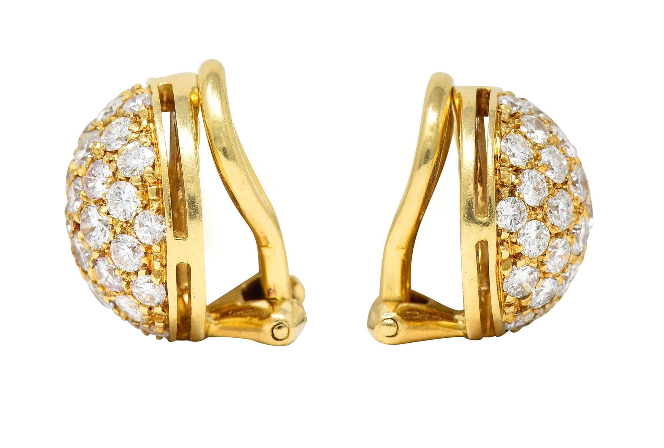 Ear-clips are 12.0 mm round dome forms

Pavè set throughout by round brilliant cut diamonds

Weighing in total approximately 1.10 carats with F/G and VS clarity

Completed by hinged omega backs

Stamped 750 for 18 karat gold

Numbered and fully